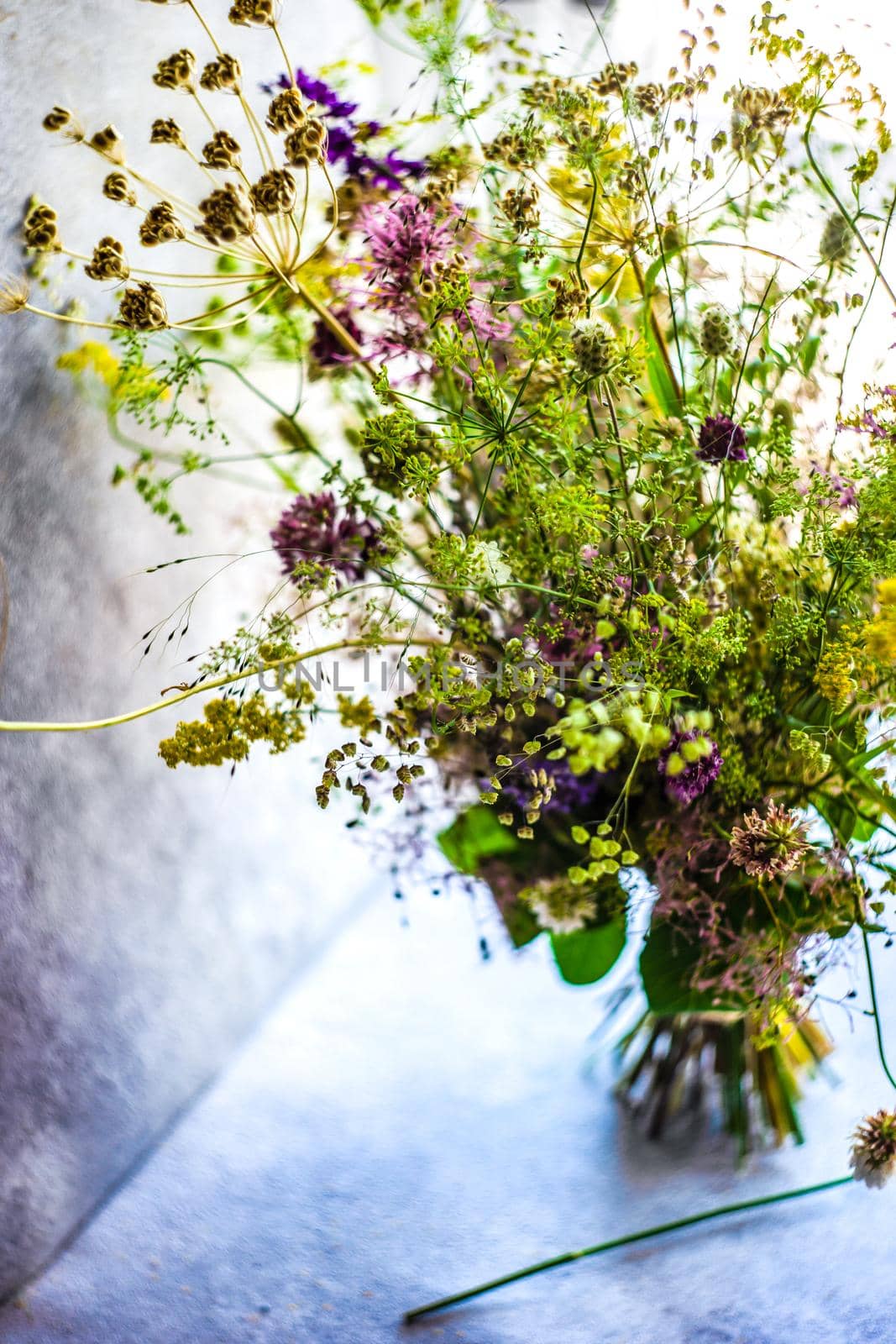Summer wild flowers in bouquet as a gift concept in interior