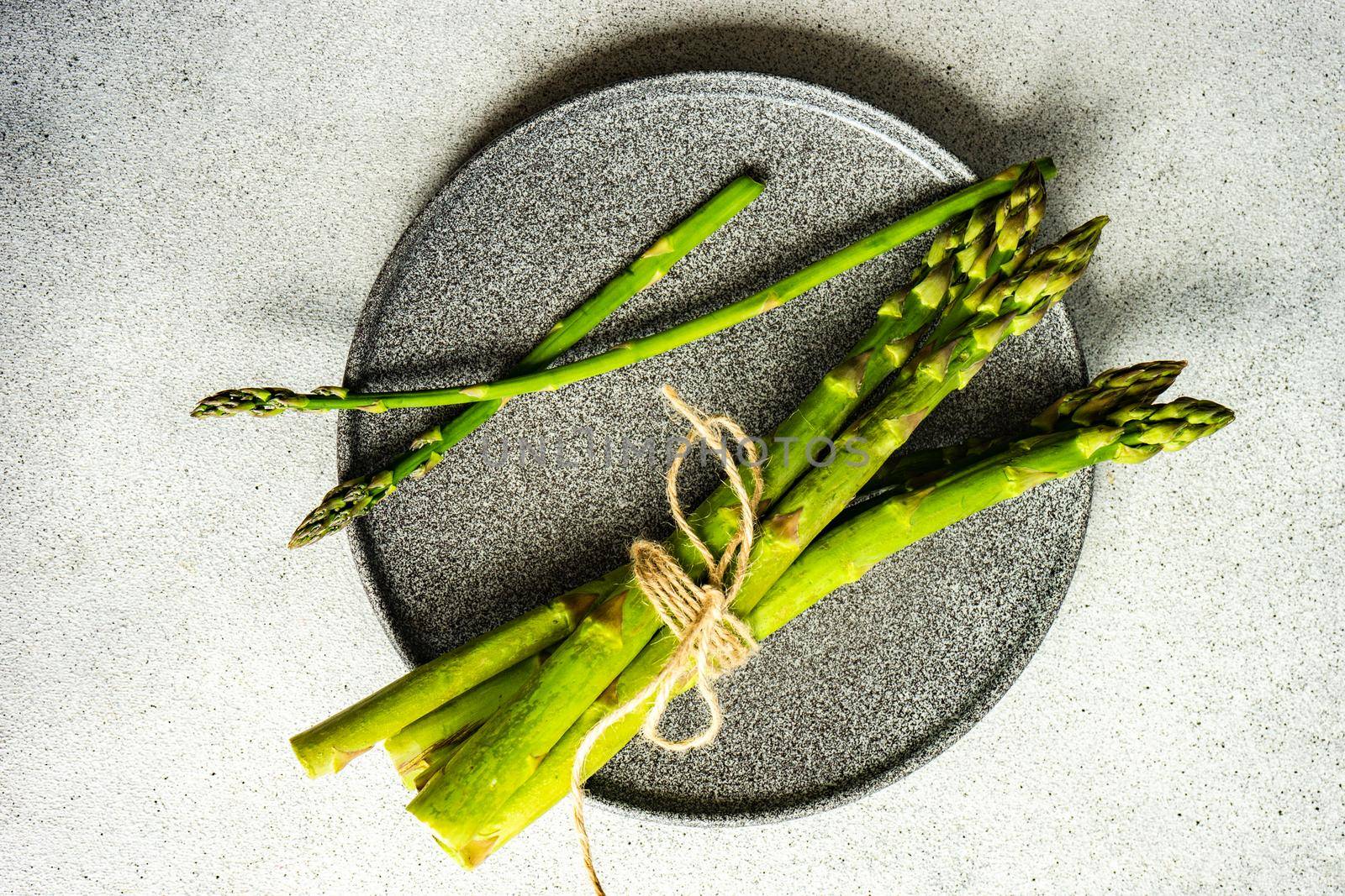 Organic food concept with asparagus on stone table with copy space