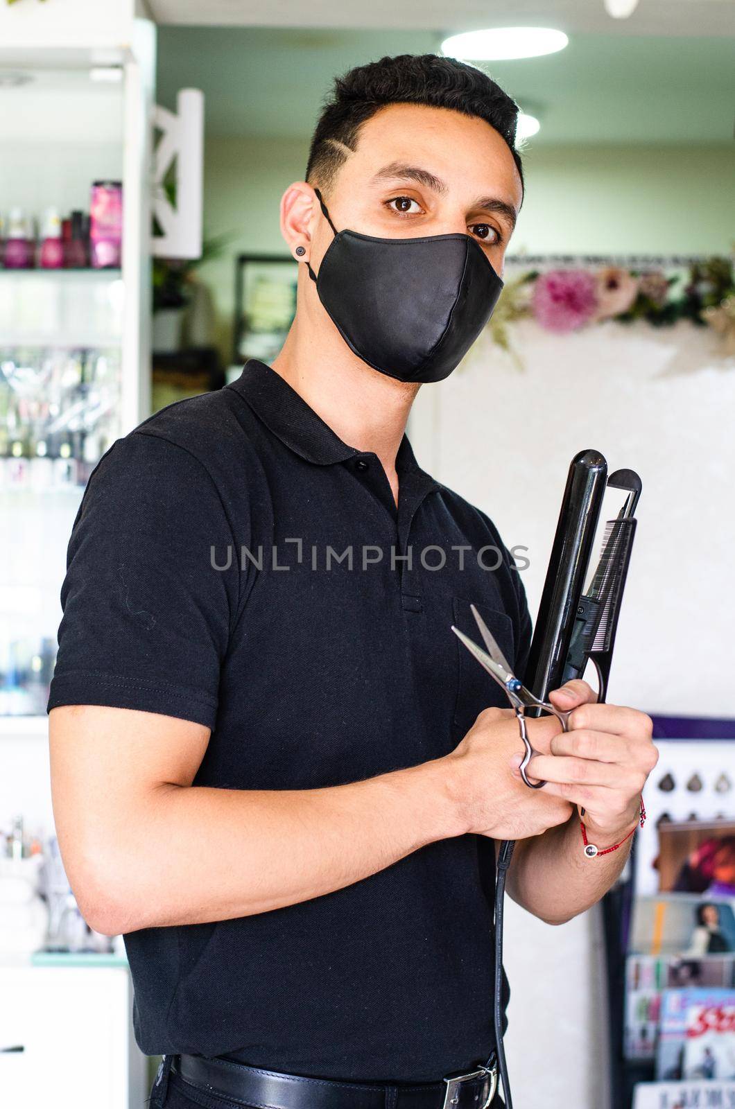Barber Shop. The hairdresser has a scissors and a comb, with a mask for the pandemic. by Peruphotoart