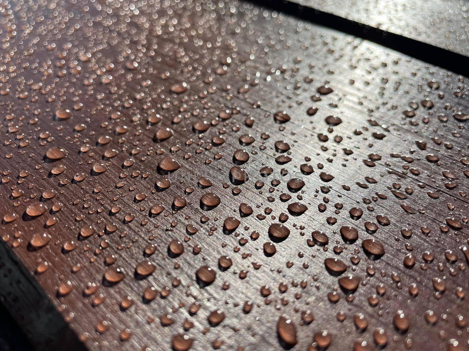 Lots of water drops on dark wood background