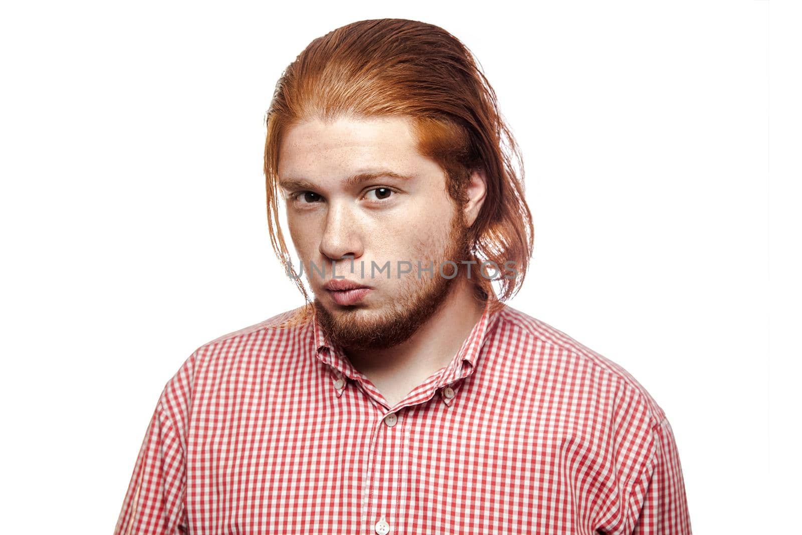 Kissing sexy bearded readhead businessman with red shirt and freckles and glasses looking at camera. studio shot isolated on white.