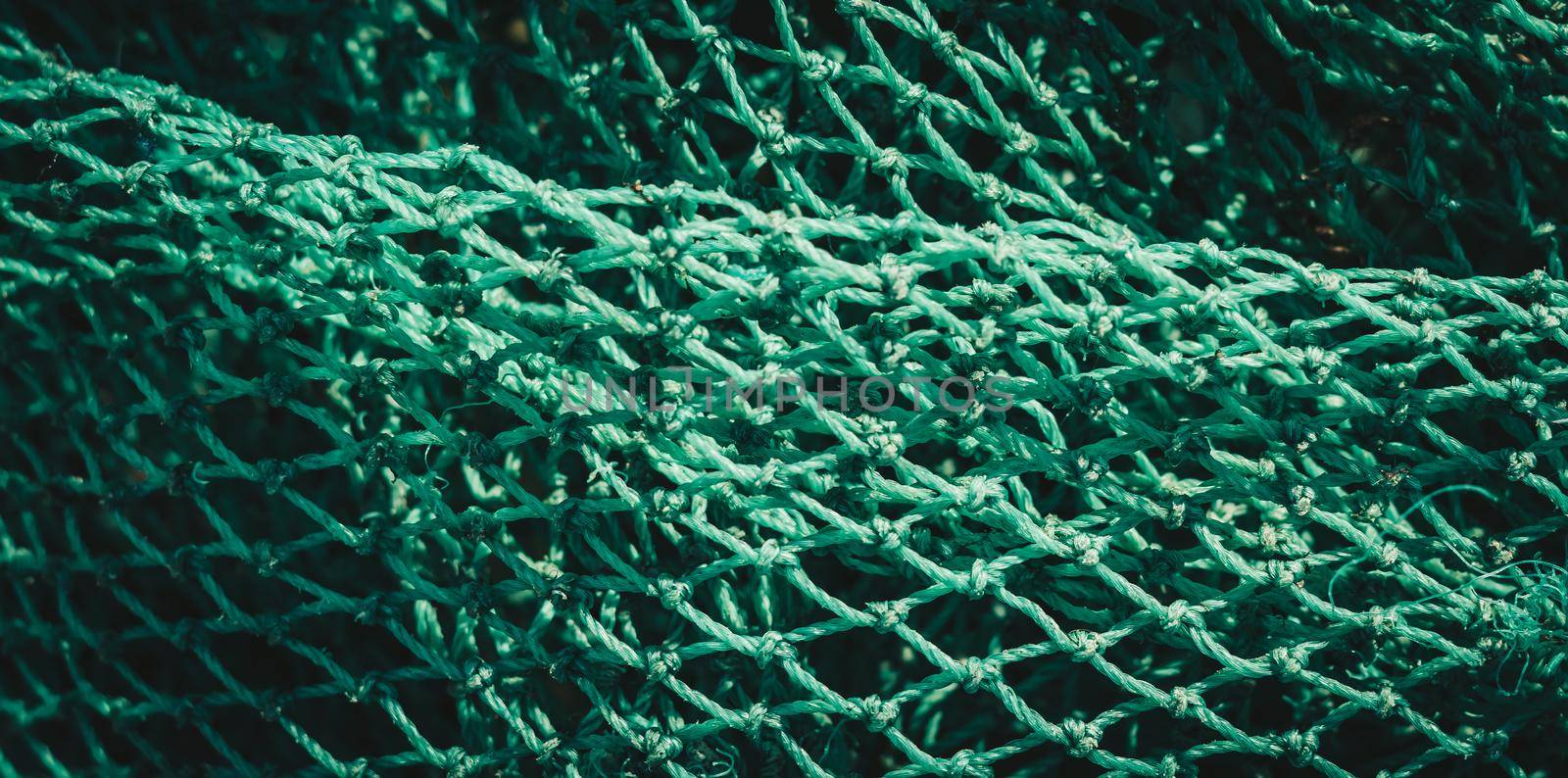 BANNER abstract close-up macro real photo beautiful wallpaper. Fisherman rope net texture fiber surface pattern. Sea blue green light colour. Futuristic subtle waving lines art modern Dark background