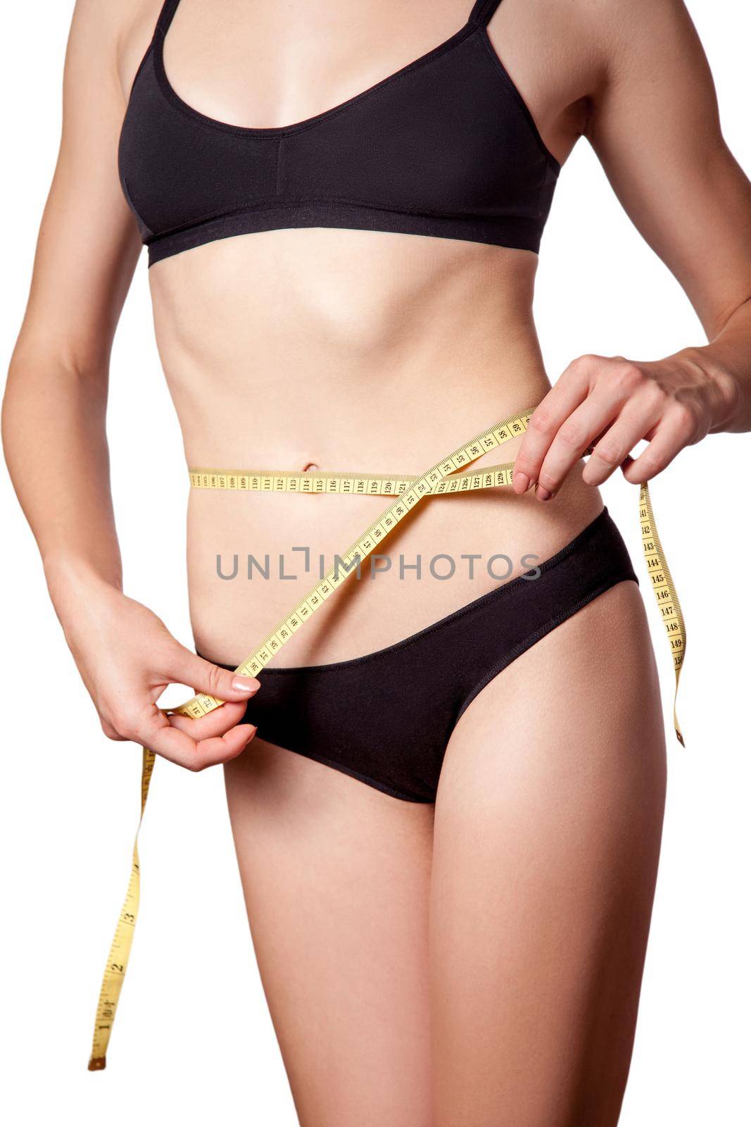 Slim fit happy young woman with measure tape measuring her waist with black underwear, isolated on white background. studio shot.