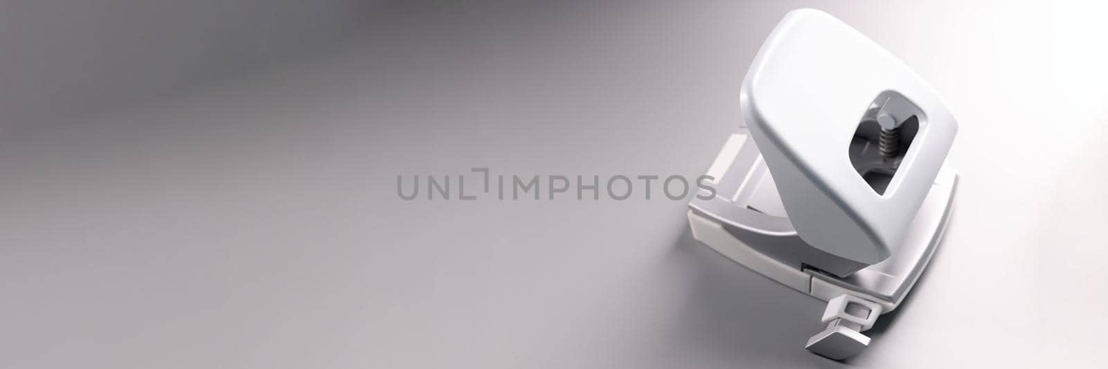 Closeup of white hole punch on gray background by kuprevich