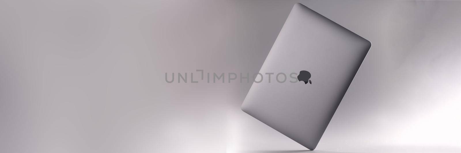 MINSK, BELARUS - DECEMBER 6, 2021: new digital laptop Apple MacBook air on gray background by kuprevich
