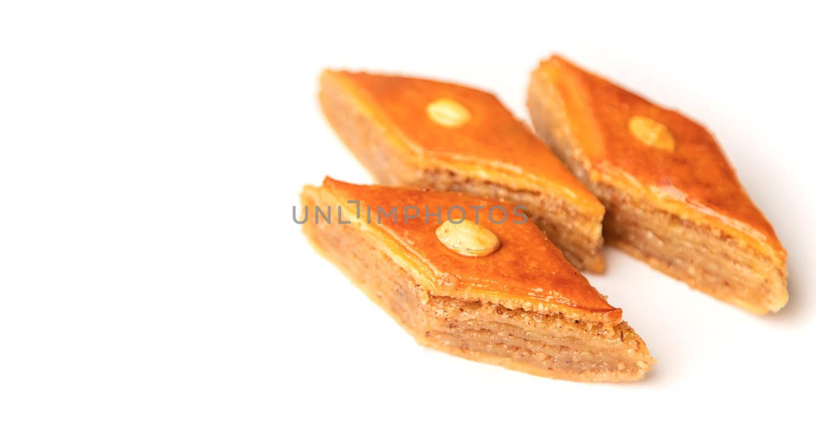 Oriental sweet baklava isolate on a white background. Selective focus. by yanadjana