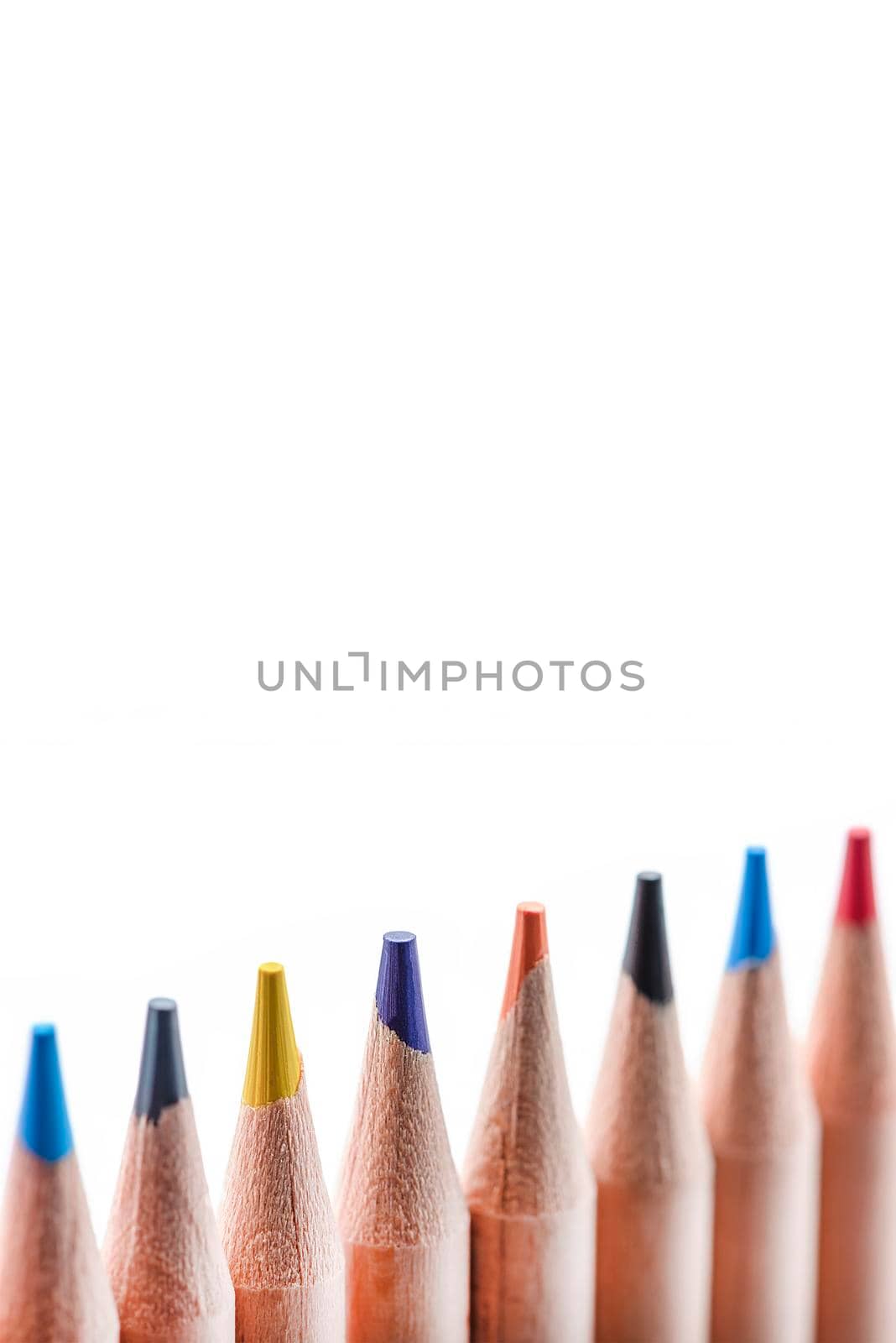 Isolate of multicolored wooden pencils. Pencils of different colors ,arranged in a rowstand out against a uniform white background, for insertion into a project or for printing a banner or label