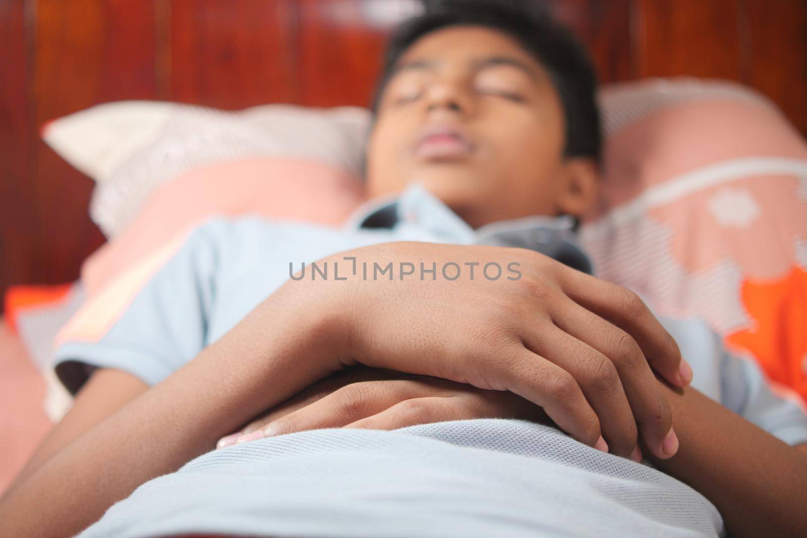 teenage boy boy sleeping in bed, selective focus