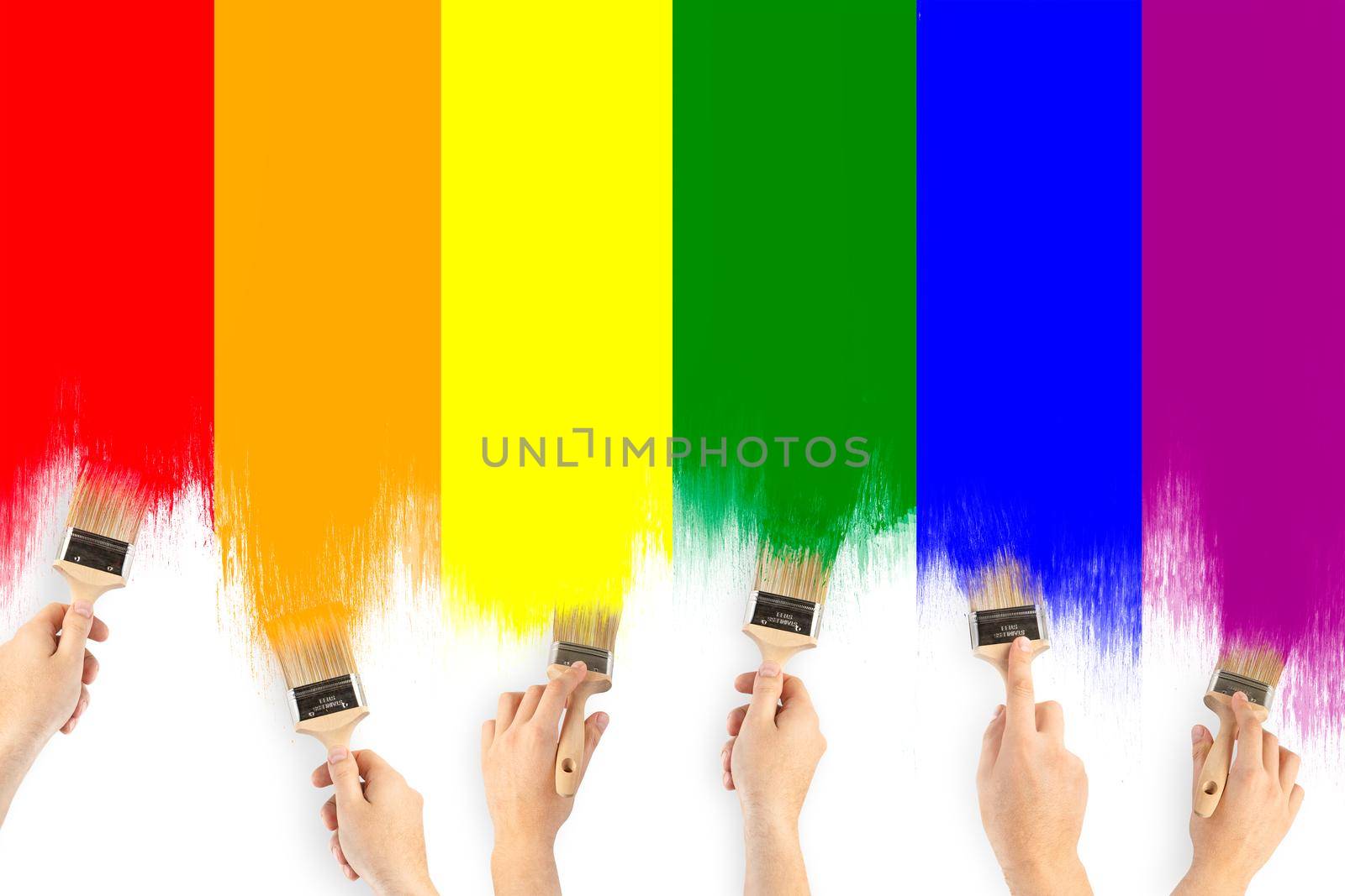 LGBT community flag. A man's hands are brushing the flag of the gay community. Rainbow close up with oil paints on white background.