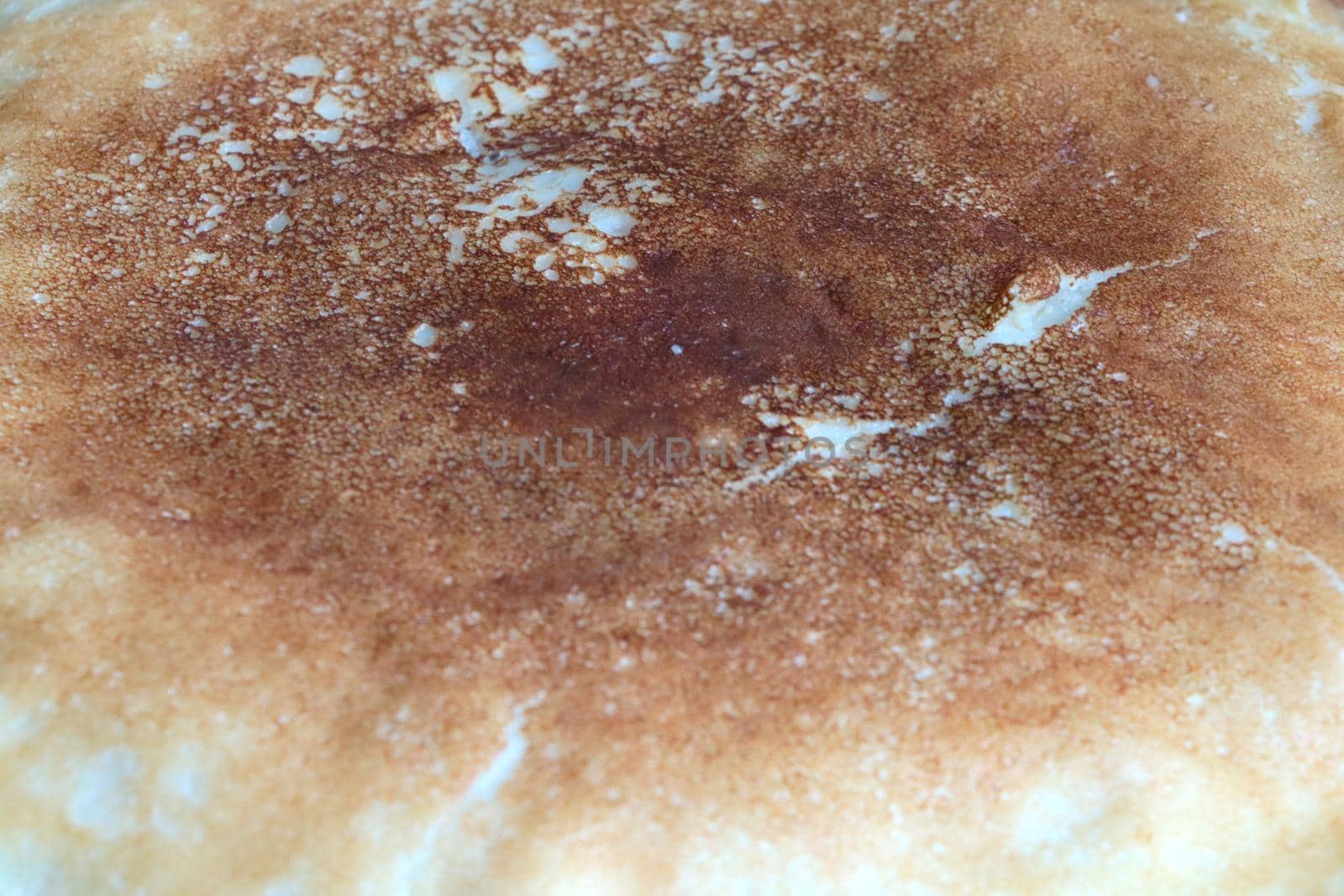 Close-up of a pancake cooking in a frying pan. Homemade food