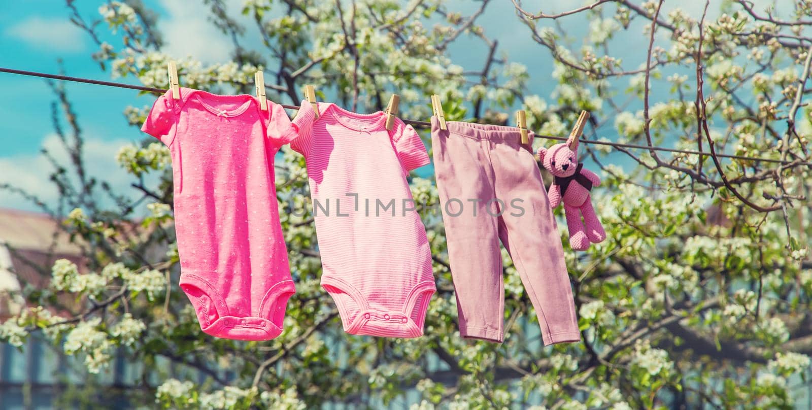 Baby clothes are drying on the street. Selective focus. by yanadjana