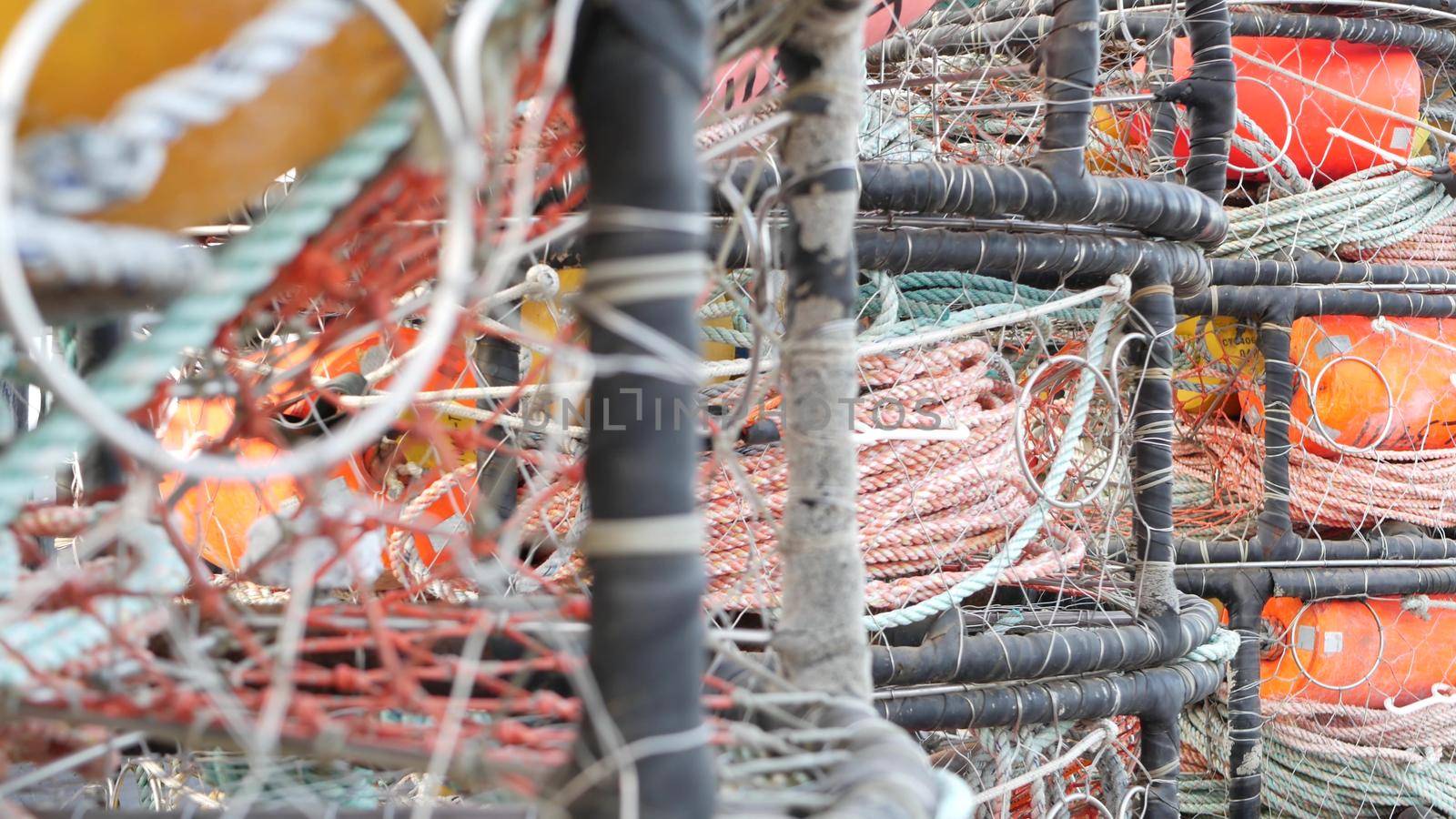 Traps, ropes and cages on pier, commercial dock, fishing industry, Monterey California USA. Empty pots, creels for fish seafood catching in port. Many fisherman's nets and baskets in seaport. Fishery.