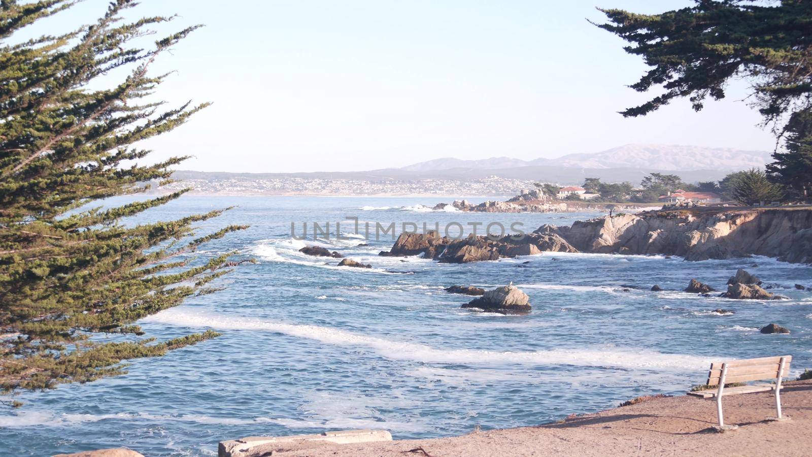 Rocky craggy ocean beach, big sea waves crashing on shore, Monterey 17-mile drive, California coast, USA. Water splashing in Pacific Grove, beachfront waterfront promenade, waterside park seascape.