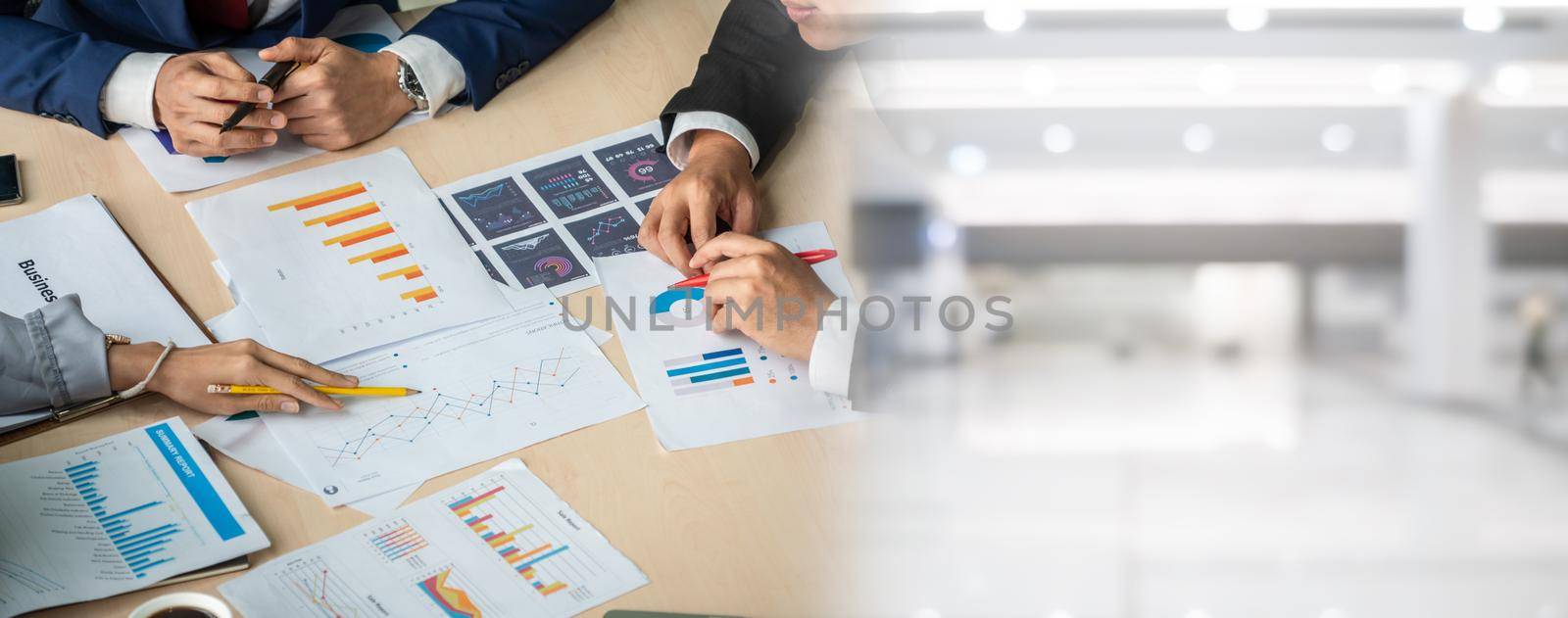 Smart businessman and businesswoman talking discussion in widen group meeting at office table in a modern office interior. Business collaboration strategic planning and brainstorming of coworkers.