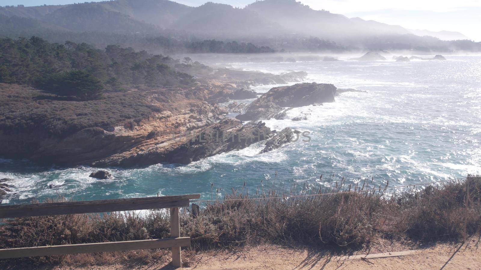 Rocky craggy ocean beach, Point Lobos, foggy California coast. Waves crashing. by DogoraSun
