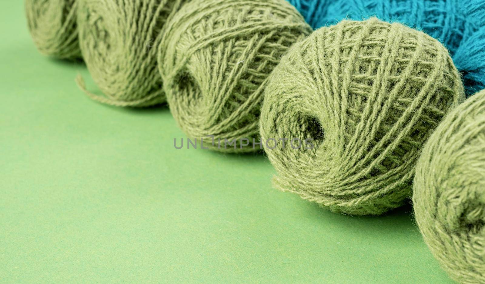 bright green yarn wool in a raw on bright background by Desperada