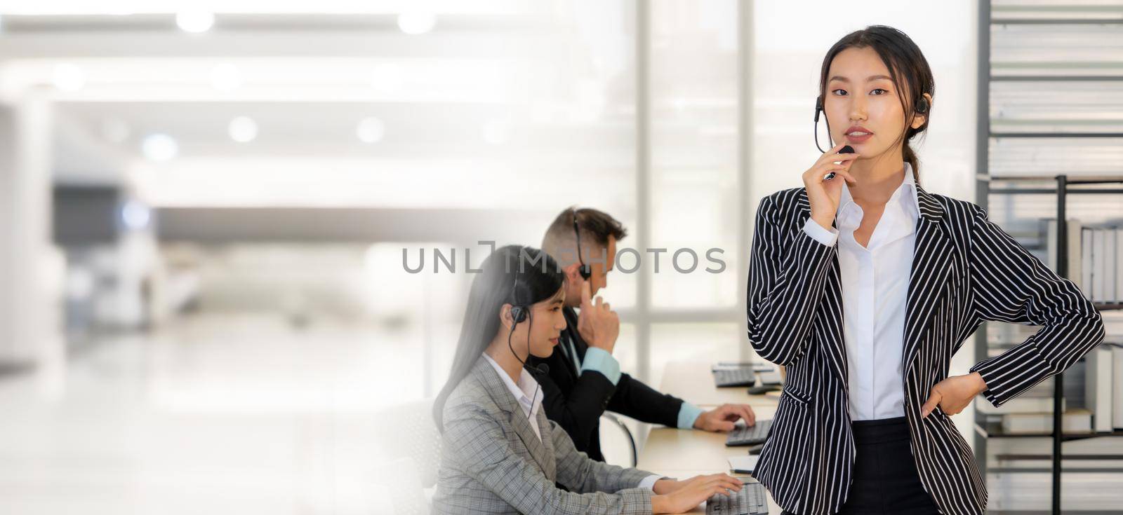 Business people wearing headset working in office to support remote customer or colleague. Call center, telemarketing, customer support agent provide service in broaden view .