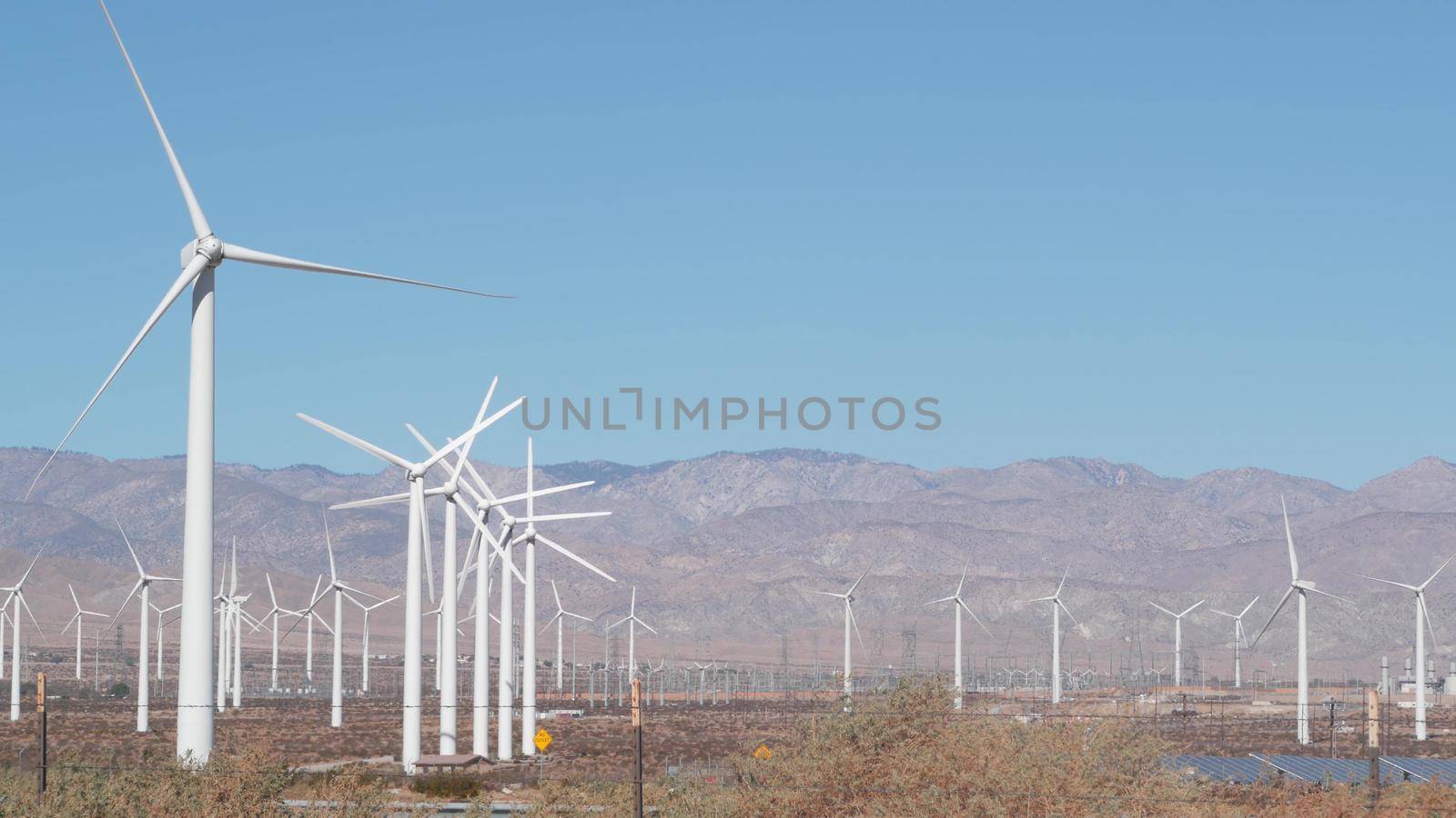 Windmills on wind farm, wind mill energy generators. Desert windfarm power plant by DogoraSun