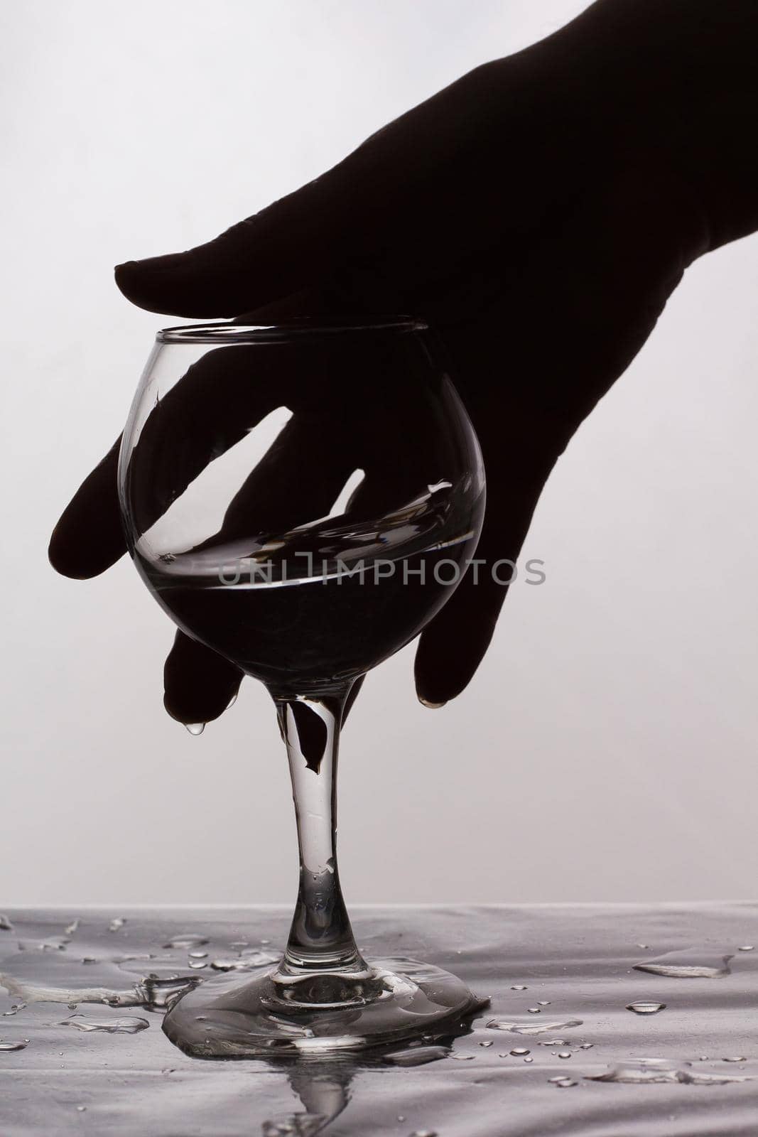 A woman's hand reaches for a glass of spilled wine. Female alcoholism by lara29