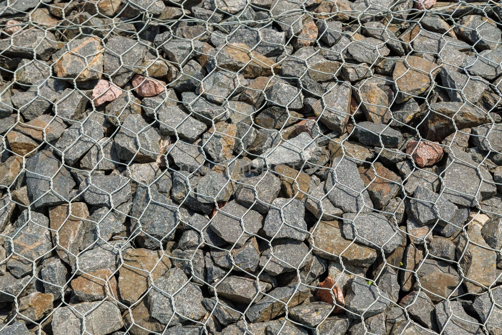 granite gravel reinforcement of road embankment covered wth steel mesh - full-frame background by z1b