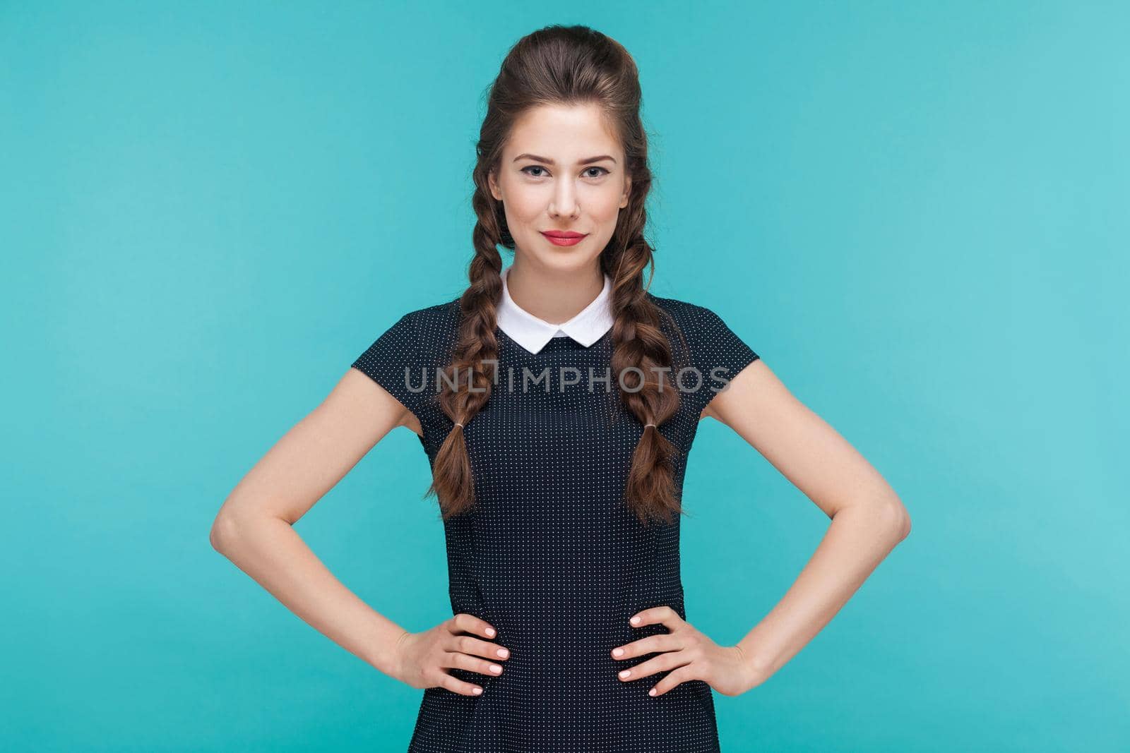 Beautiful young woman smile and looking at camera. Indoor, studio shot on blue background by Khosro1