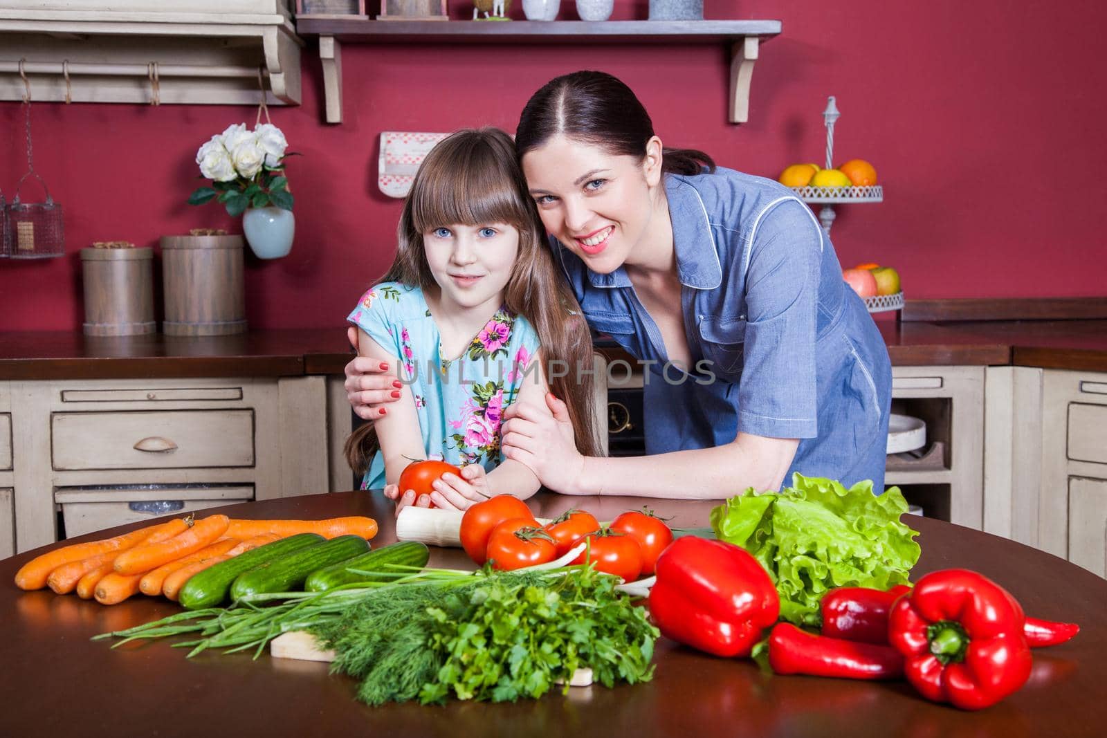 Happy mother and daughter enjoy making and having healthy meal together by Khosro1