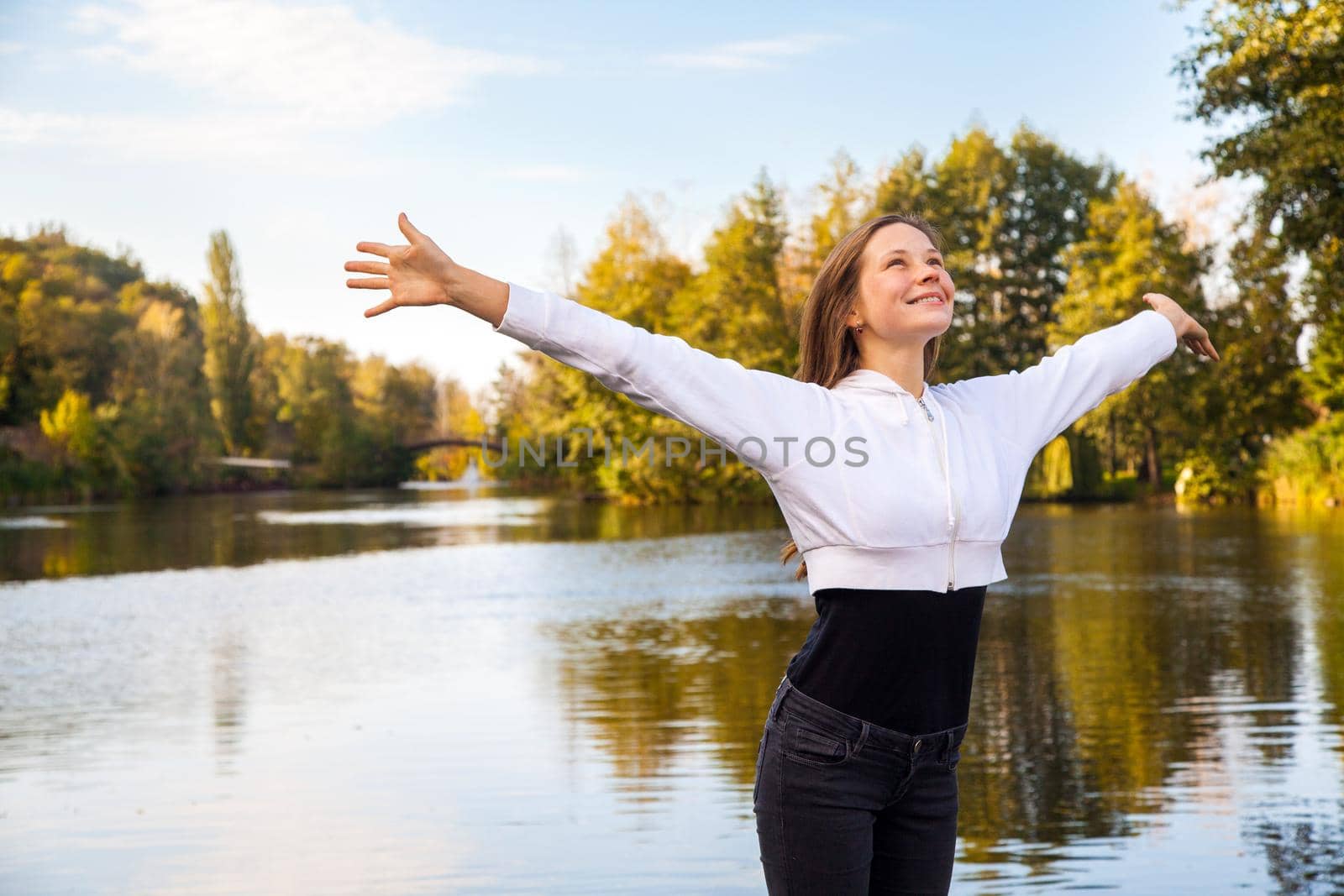 Happiness girl in the park. Autumn, fallen leaves.