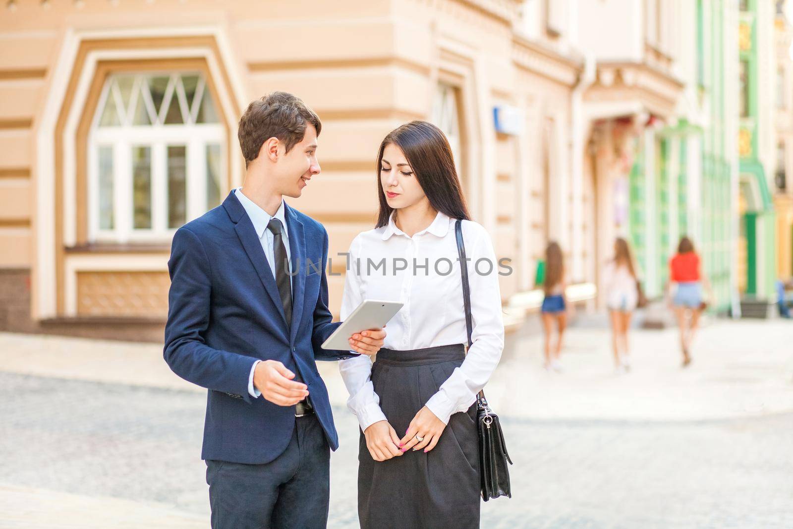 Businessman distracted and looking to sexy girls while working and discussing with partner.