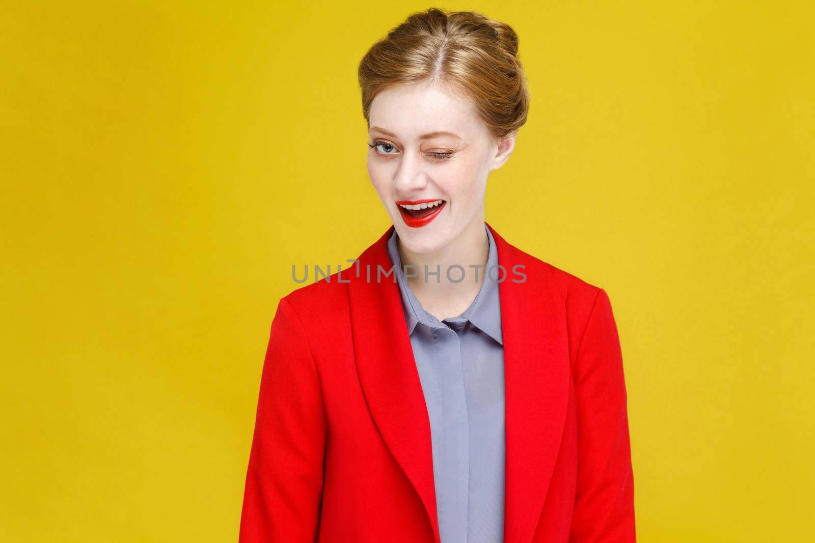 Flirt, love concept. Ginger vogue woman wink and toothy smile. Studio shot