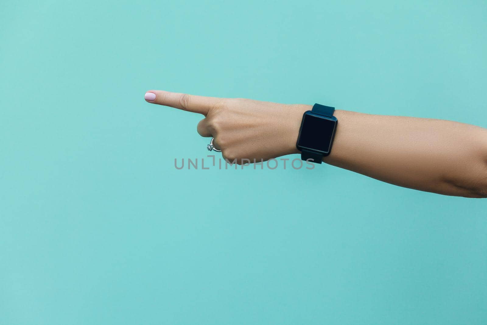 Look this! Hand finger pointing isolated on light blue background.