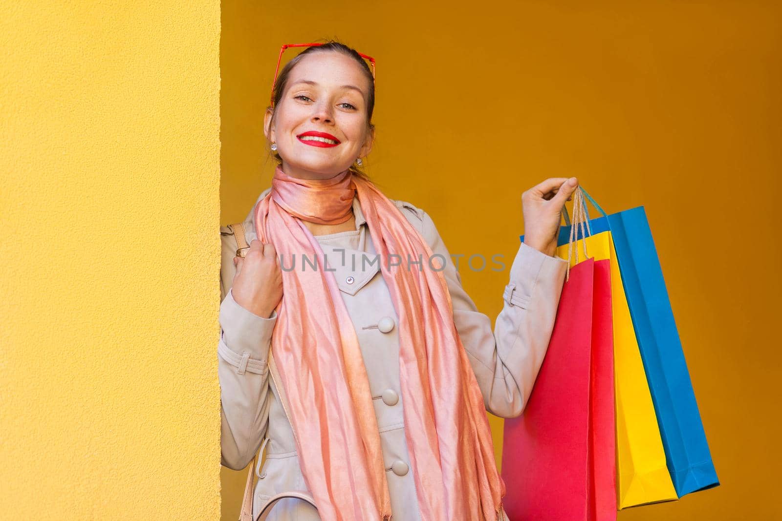 woman in casual clothing with shopping bags, looking at camera with smiling. by Khosro1