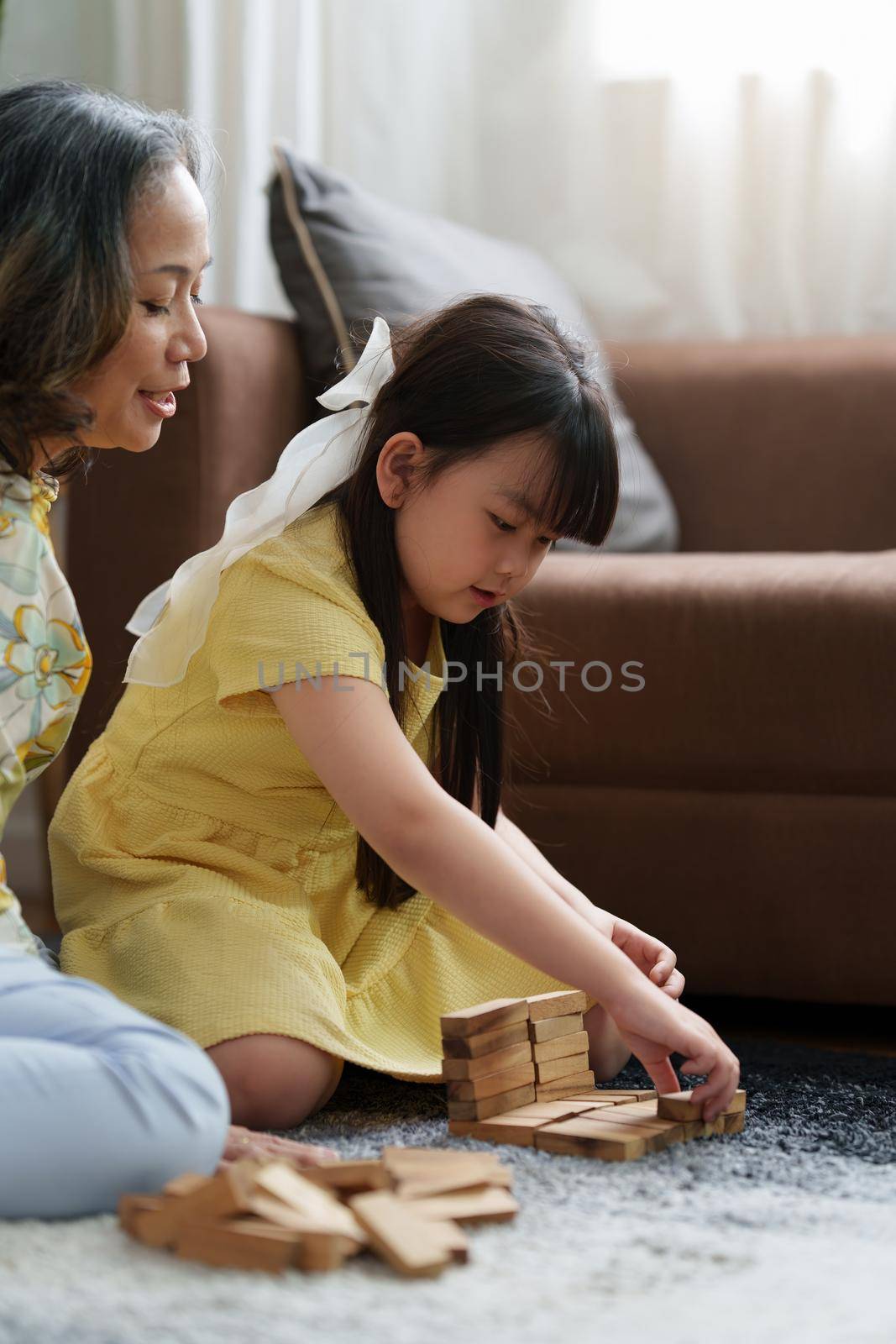 Happy moment of Daughter enjoying time together with mother at home. little child girl having fun. by itchaznong