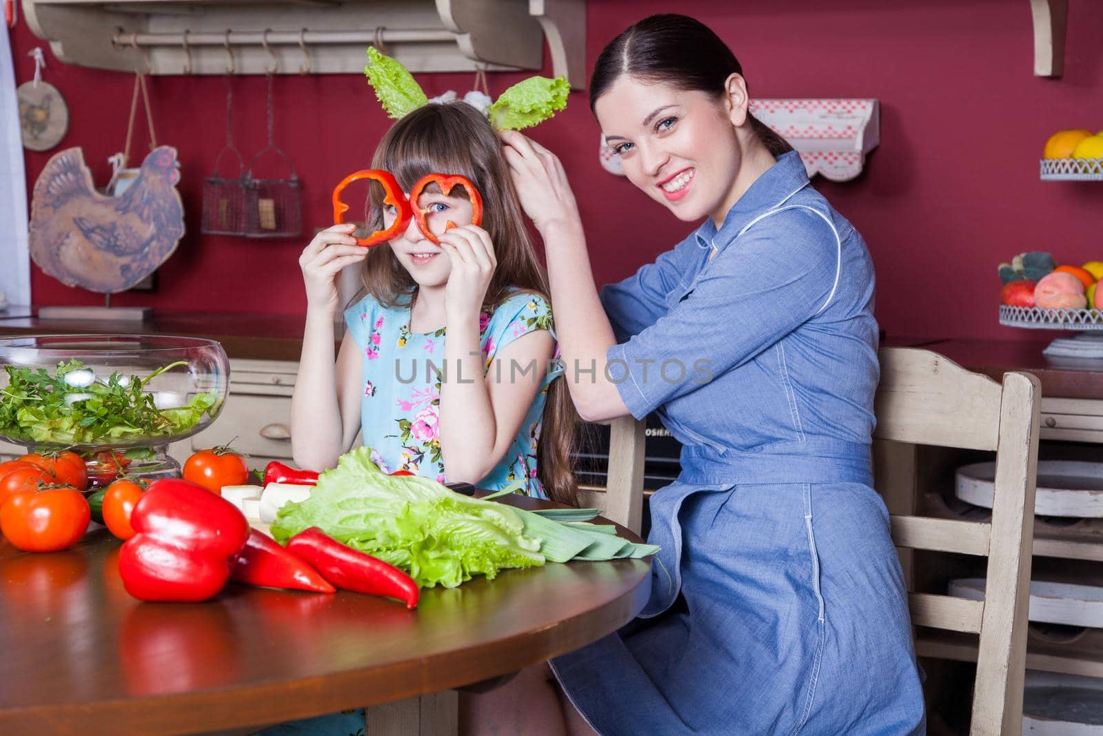 Happy mother and daughter enjoy making and having healthy meal together by Khosro1