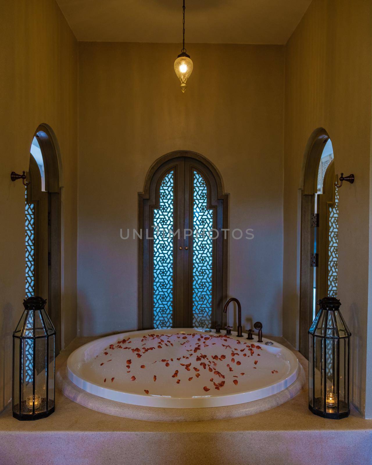 romantic bath tub with rose petals, luxury vacation in jacuzzi by fokkebok