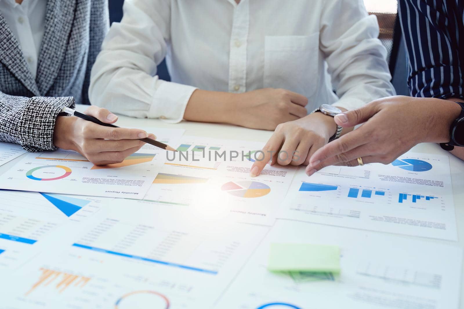 Planning to reduce investment risks, the image of a group of businesspeople working with partners is adjusting marketing strategies to analyze profitable and targeted customer needs at meetings by Manastrong