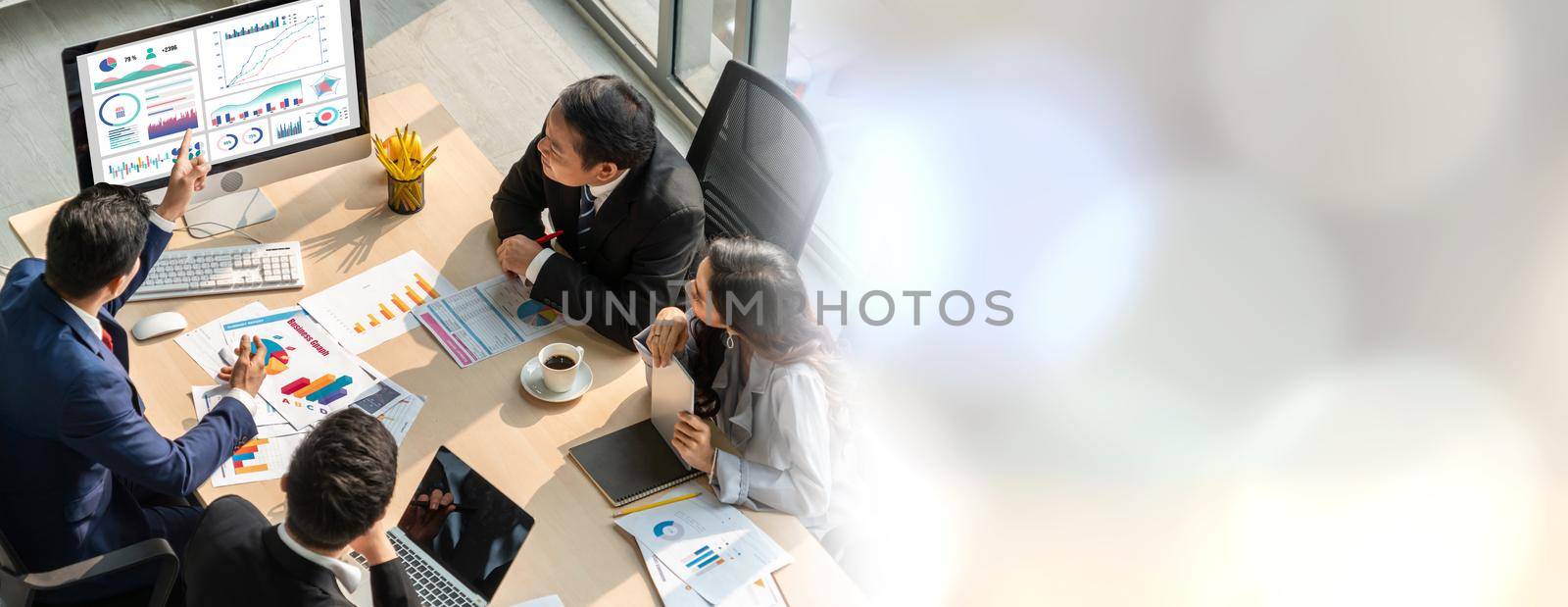 Smart businessman and businesswoman talking discussion in widen group meeting at office table in a modern office interior. Business collaboration strategic planning and brainstorming of coworkers.