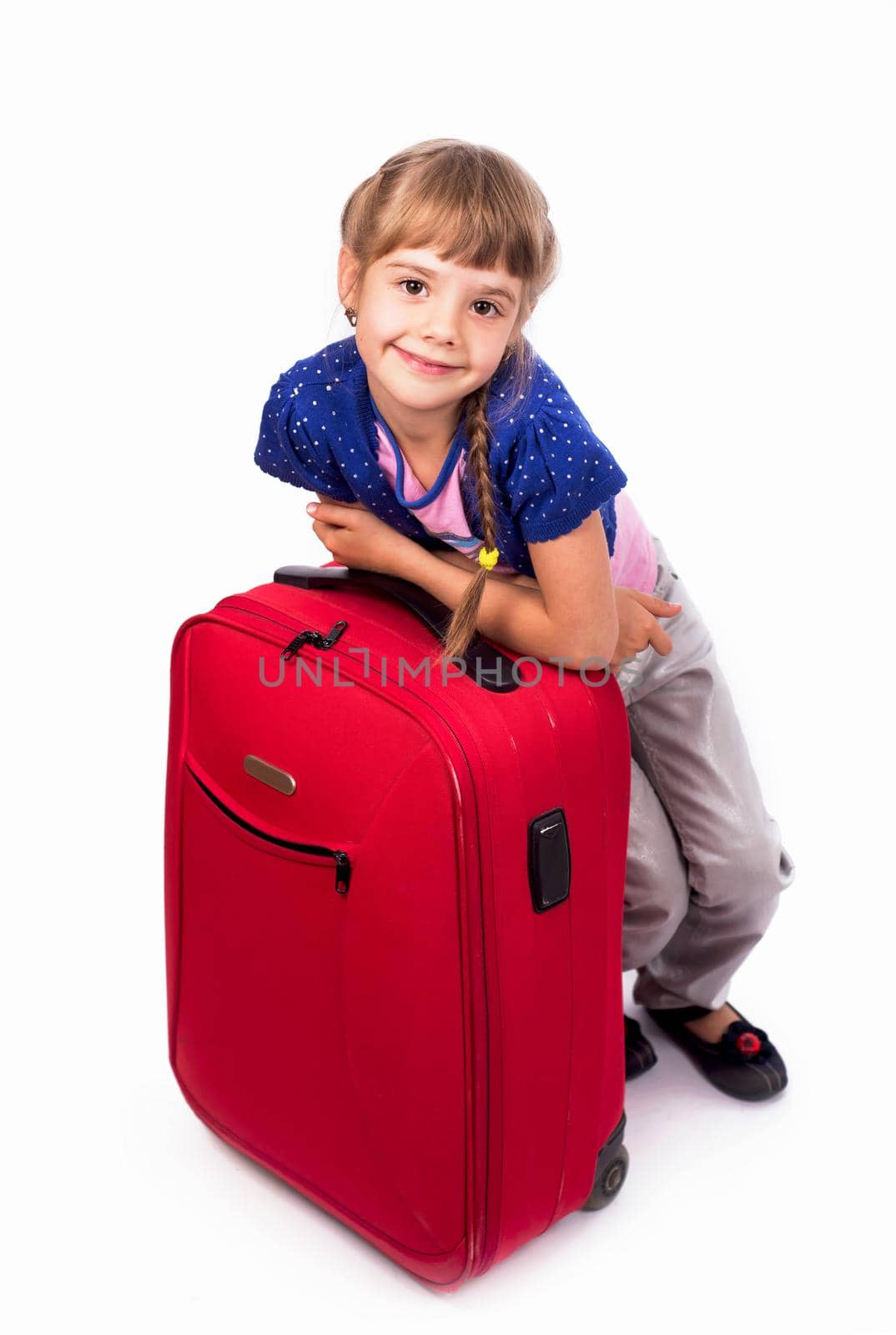 girl and big red suitcase isolated on white background