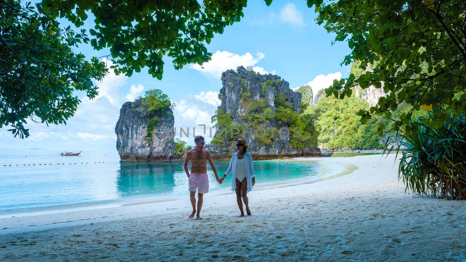 Koh Hong Island Krabi Thailand, a couple of men and women on the beach of Koh Hong, a tropical white beach with Asian women and European men in Krabi Thailand