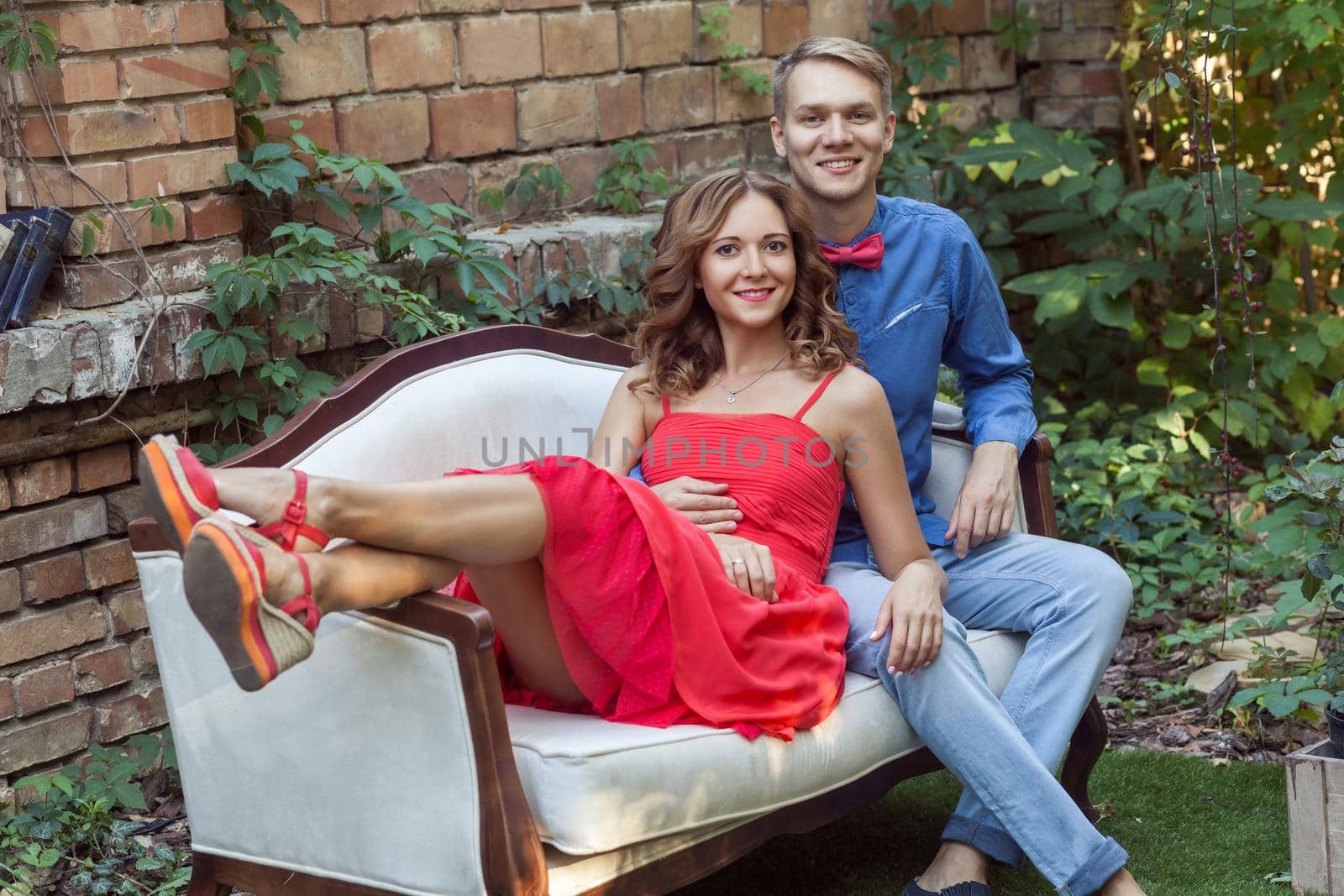 Happiness couple embrace, relaxing in park and looking at camera. Outdoor shot