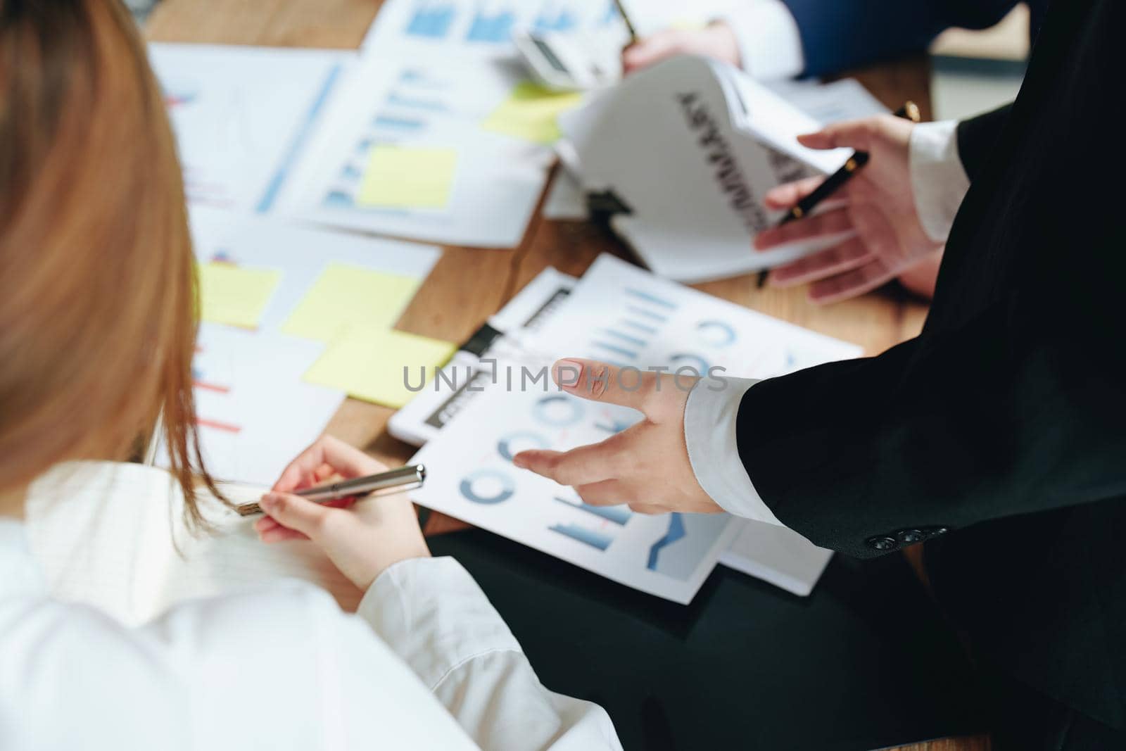 Planning to reduce investment risks, the image of a group of businesspeople working with partners is adjusting marketing strategies to analyze profitable and targeted customer needs at meetings by Manastrong