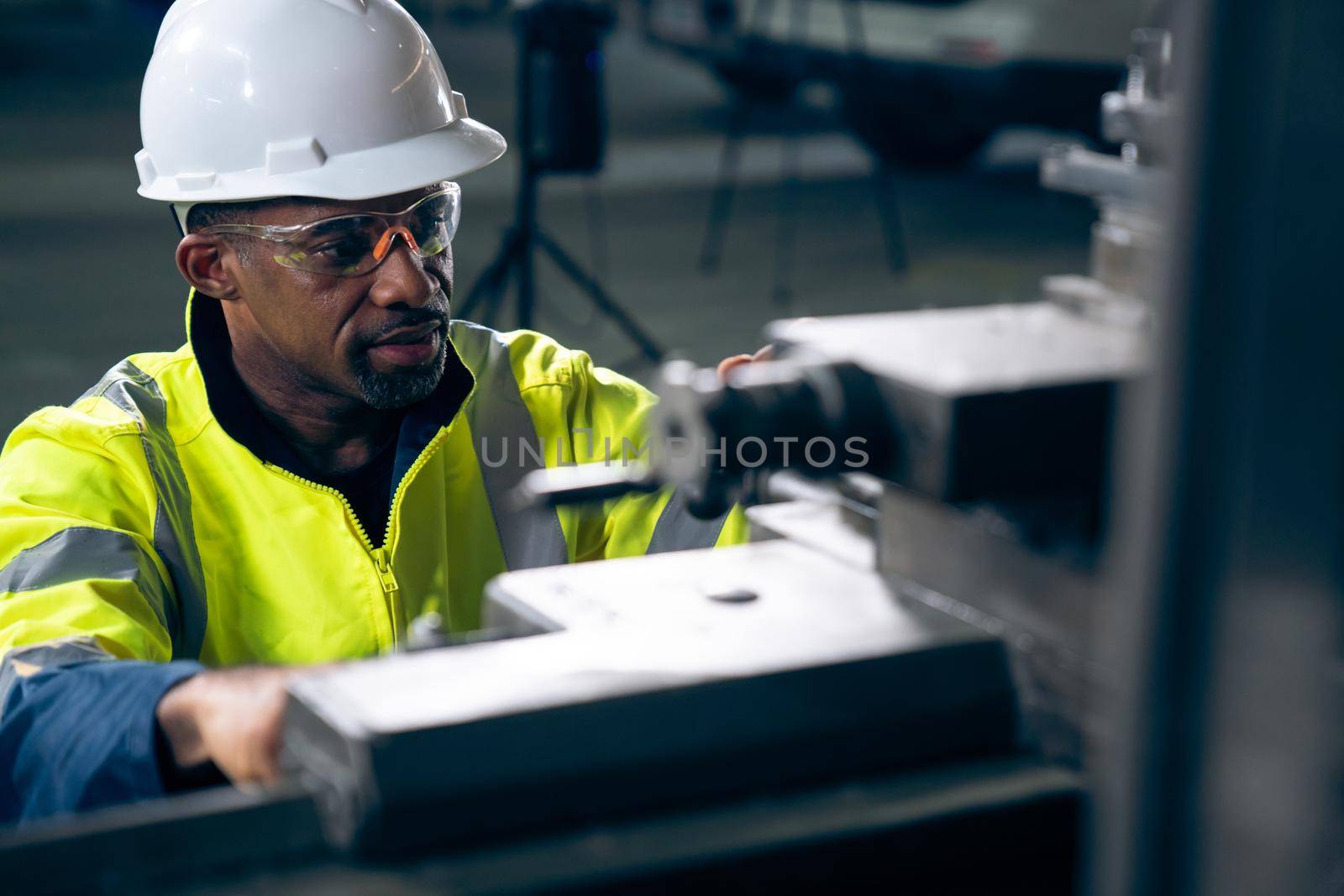 Factory worker or engineer do machine job in adept manufacturing workshop . Industrial people and manufacturing labor concept .