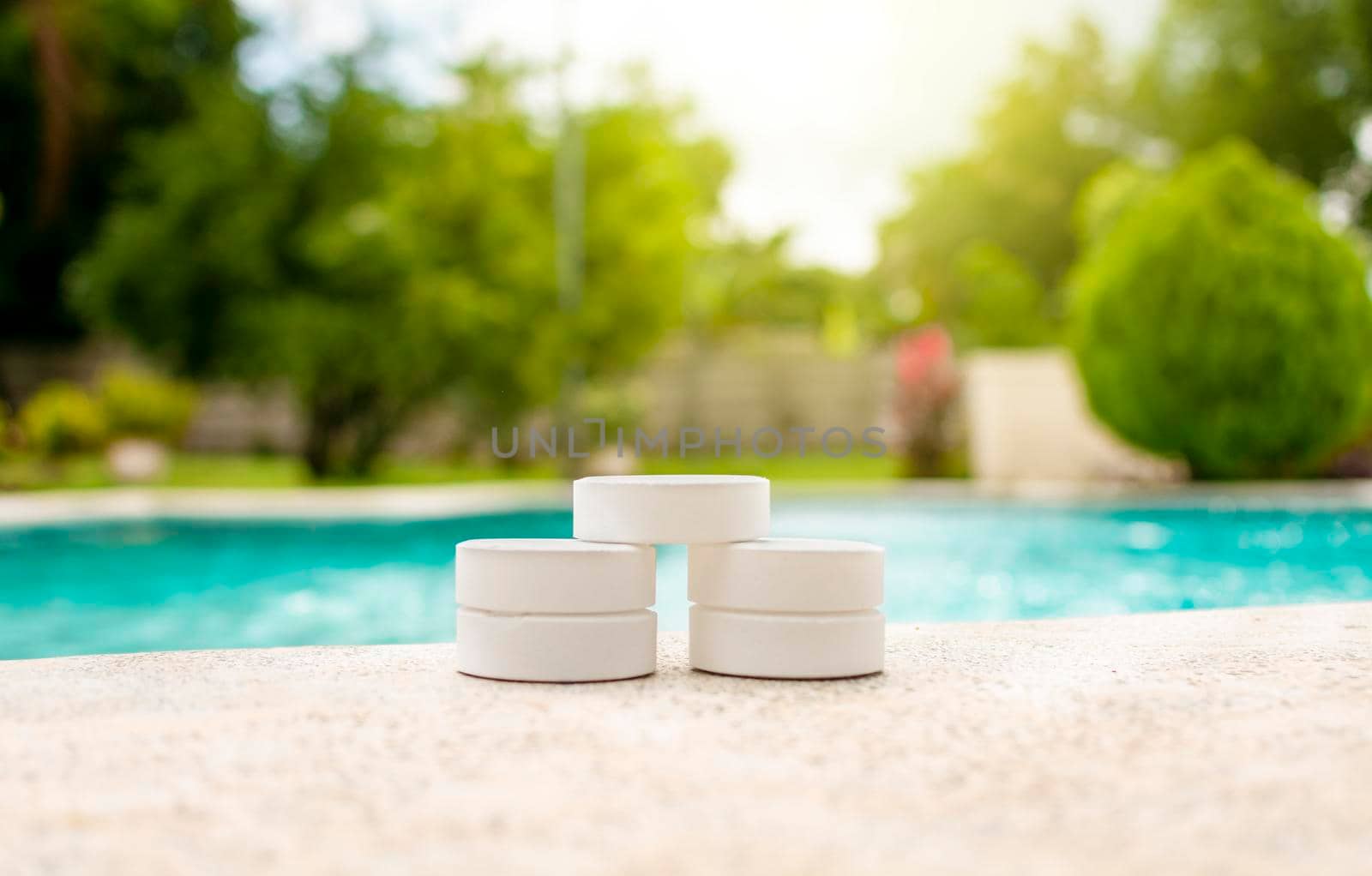 Chlorine tablets for swimming pool cleaning, close up of chlorine tablets on the edge of a swimming pool, chlorine tablets for swimming pool disinfection