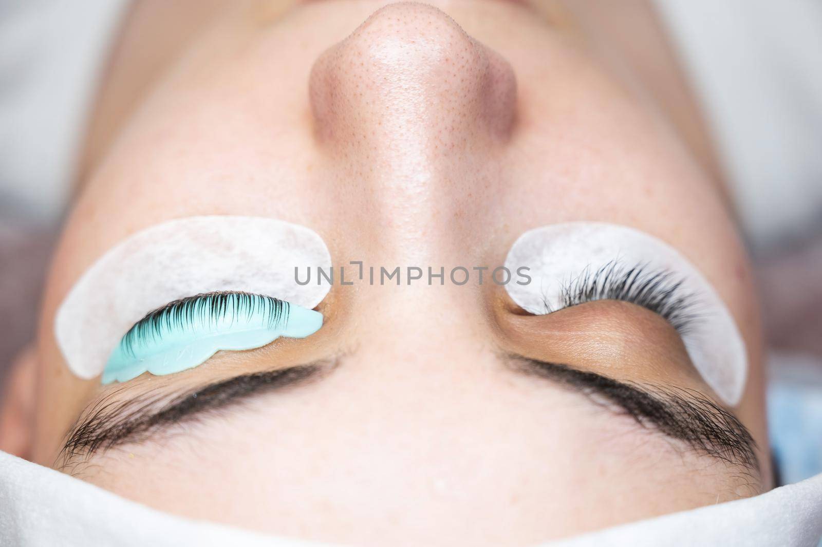 Close-up portrait of a woman in a beauty salon on eyelash lamination procedure. by mrwed54