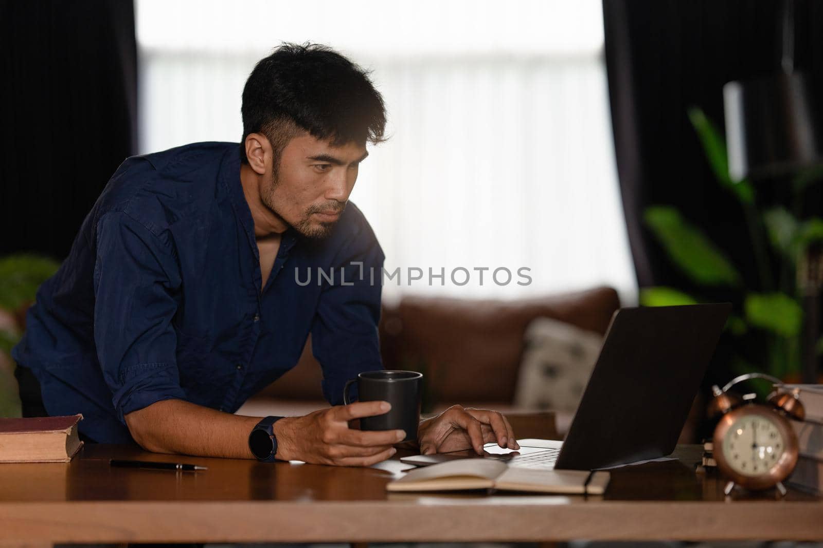 Portrait of Asian Businessman hand using calculator to calculate the company's financial results and budget. Account Audit Concept