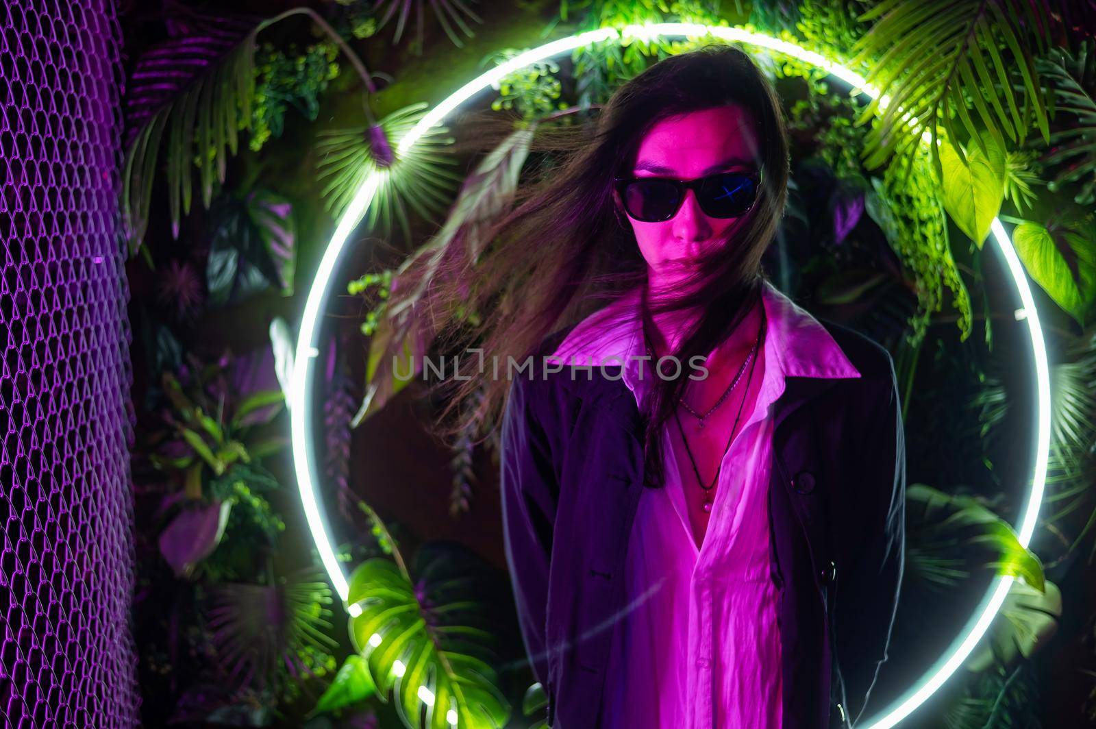 Portrait of asian man wearing sunglasses in neon light