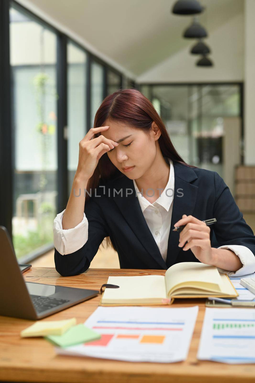 Frustrated young businesswoman stress from work or upset after finishing meeting. Emotional pressure, stress at work concept by prathanchorruangsak