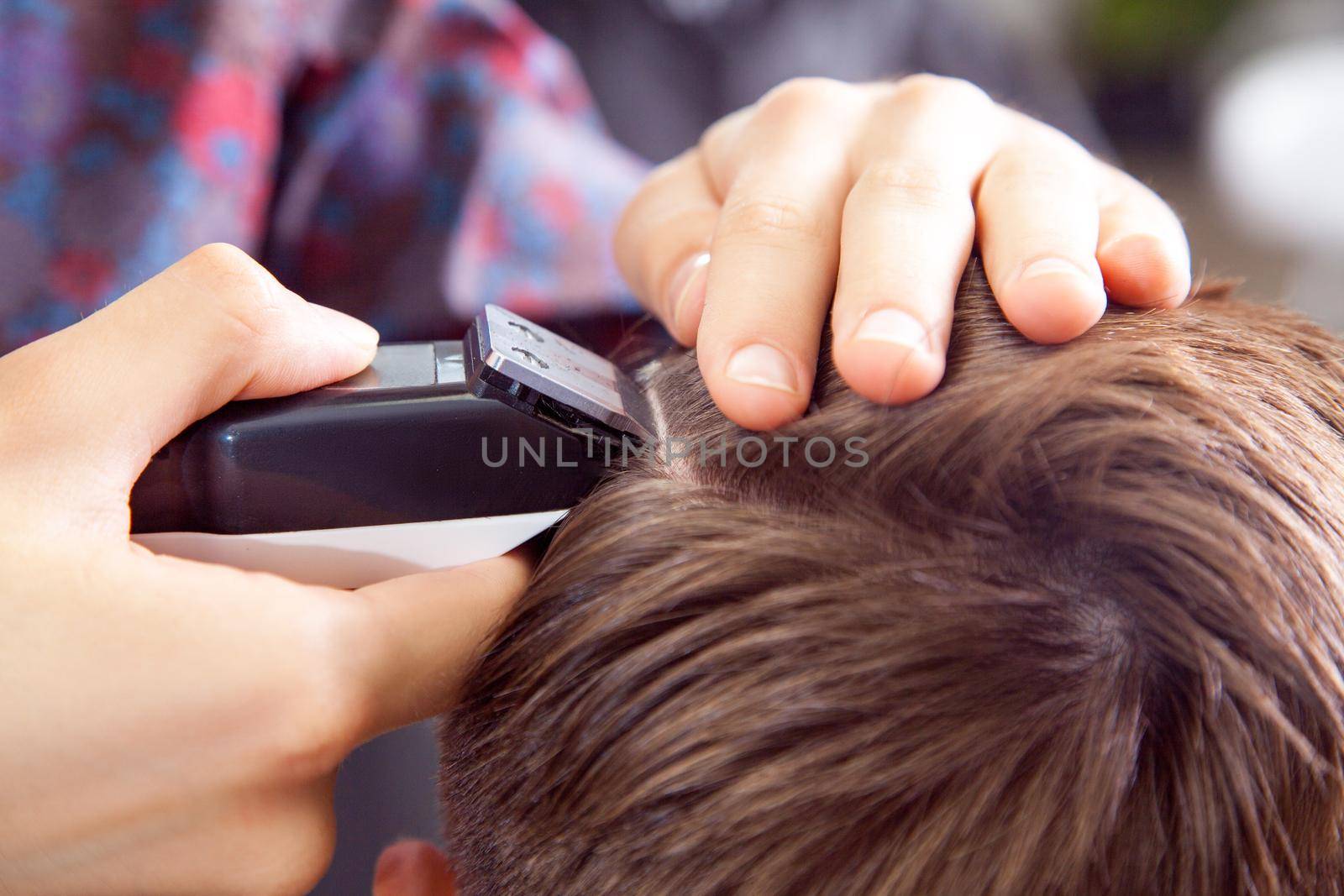 The man haircut with clipper and razor in the barber shop