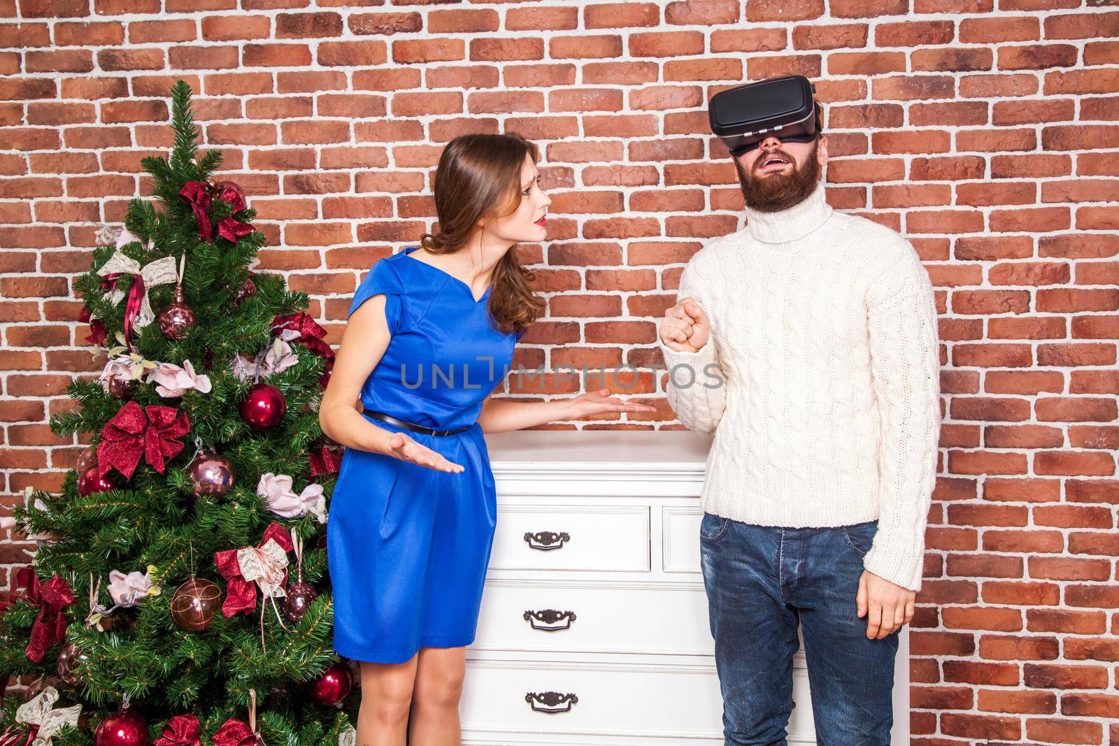 VR technology and conflict between couple. man using vr headset and his wife is angry on new year.