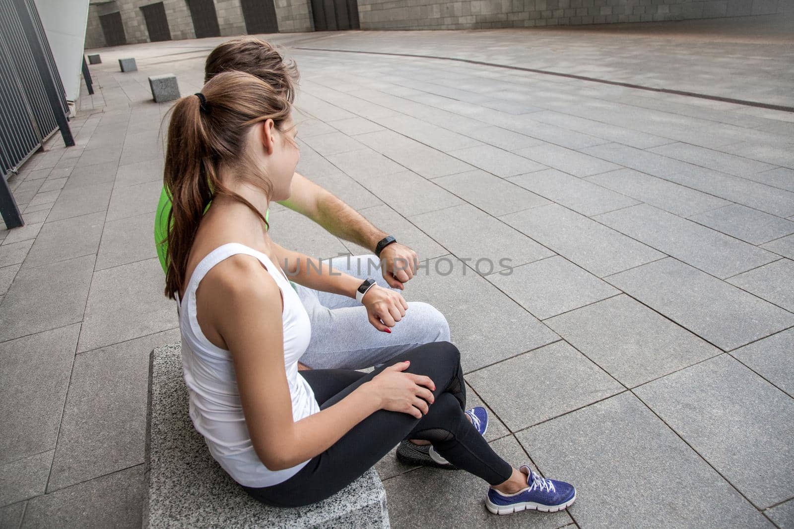 Couple using smart sport watch at workout.