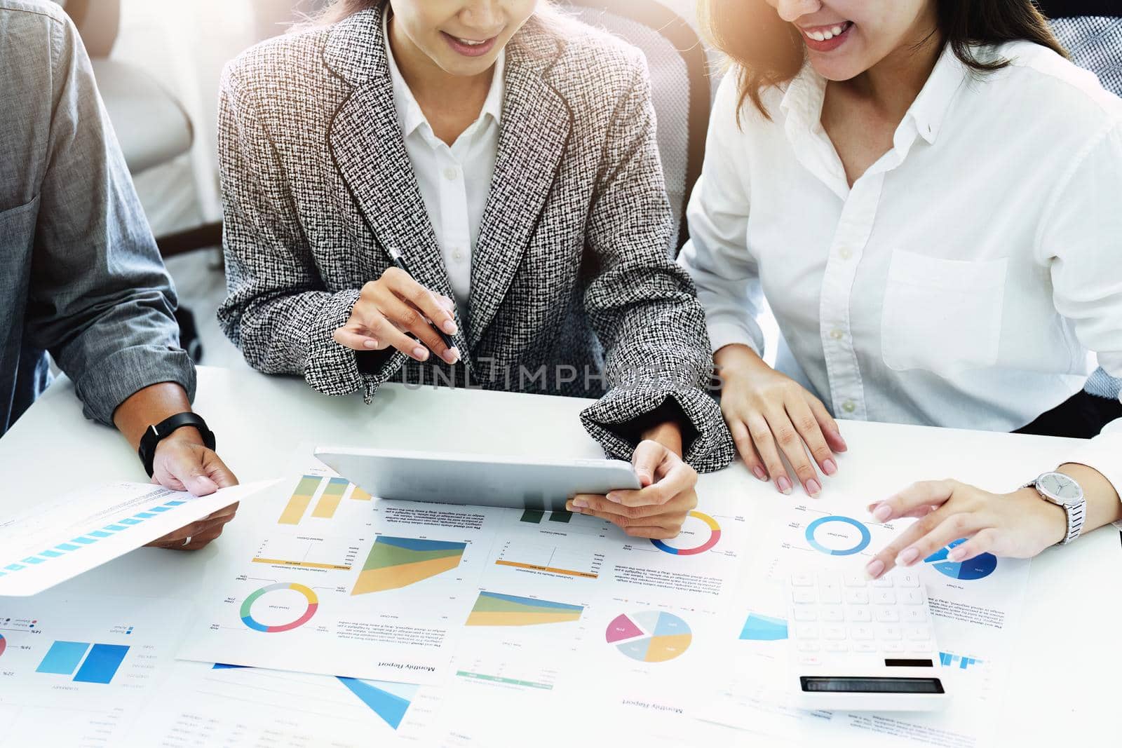 Planning to reduce investment risks, the image of a group of businesspeople working with partners is adjusting marketing strategies to analyze profitable and targeted customer needs at meetings by Manastrong